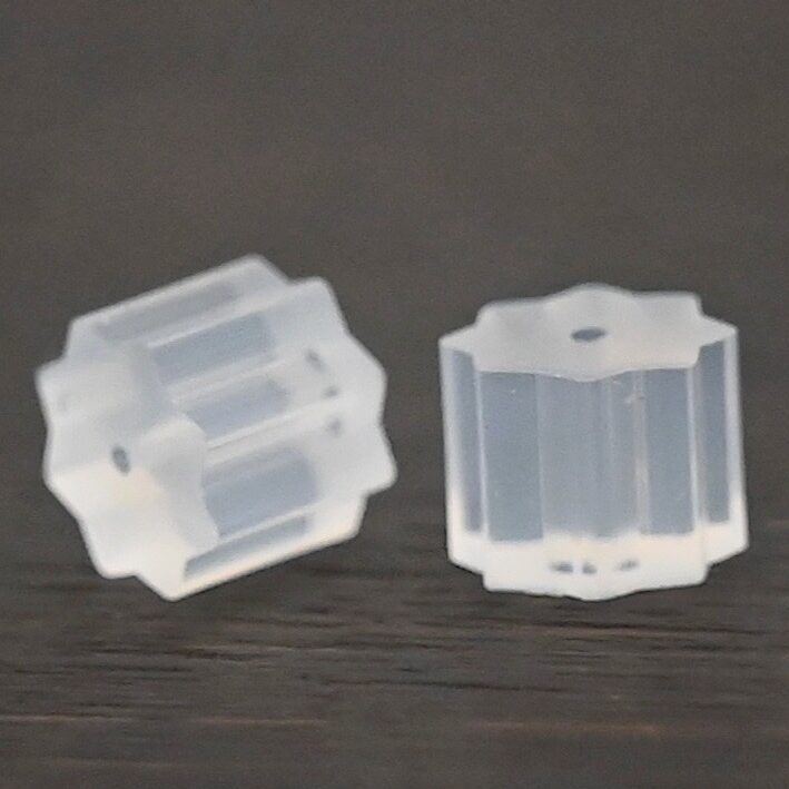 Rubber Earring Backs shown on dark background