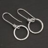 Sterling Silver Flora Hammered Circle Earrings shiny shown on dark background