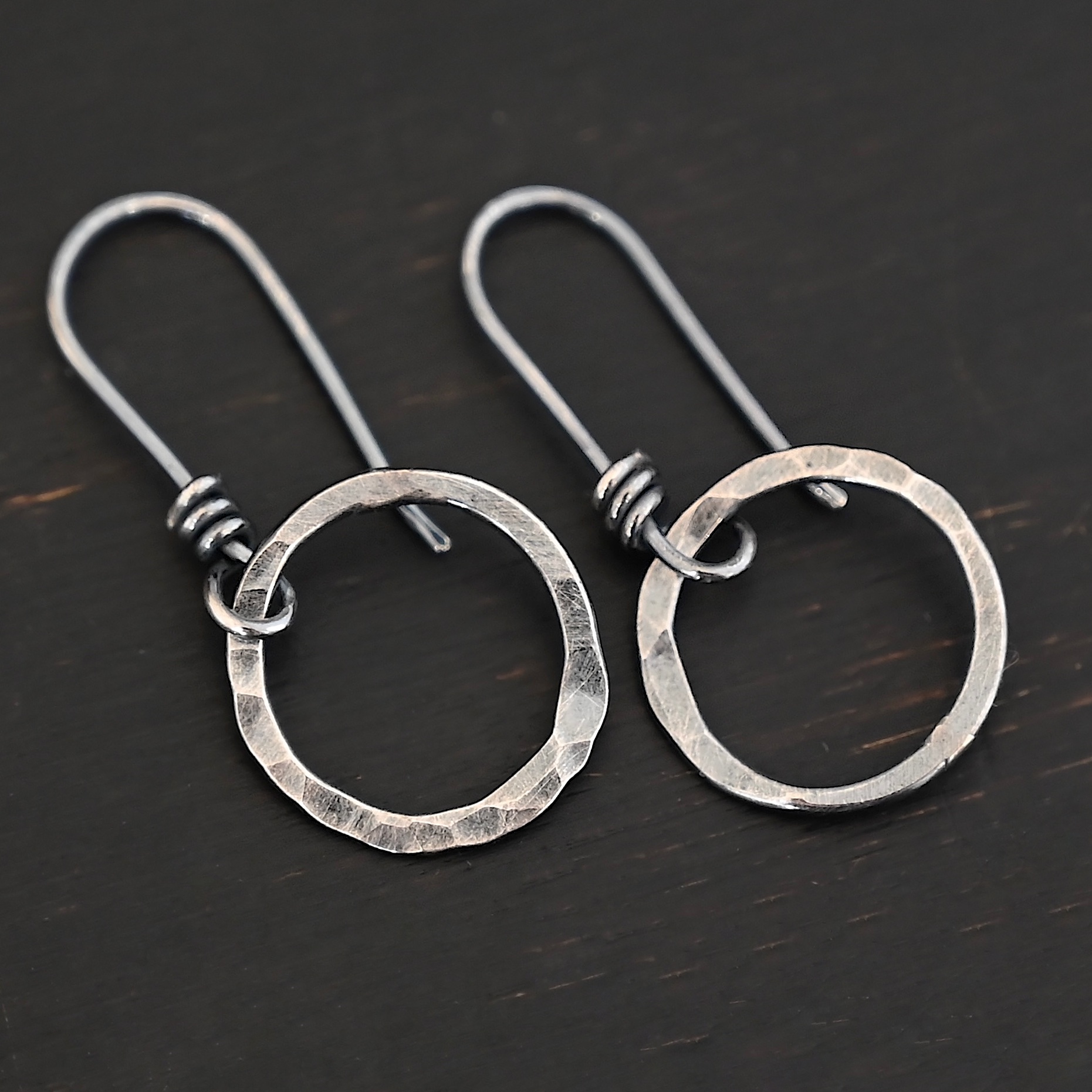 Sterling Silver Flora Hammered Circle Earrings oxidized shown on dark background