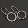 Sterling Silver Flora Hammered Circle Earrings oxidized shown on dark background