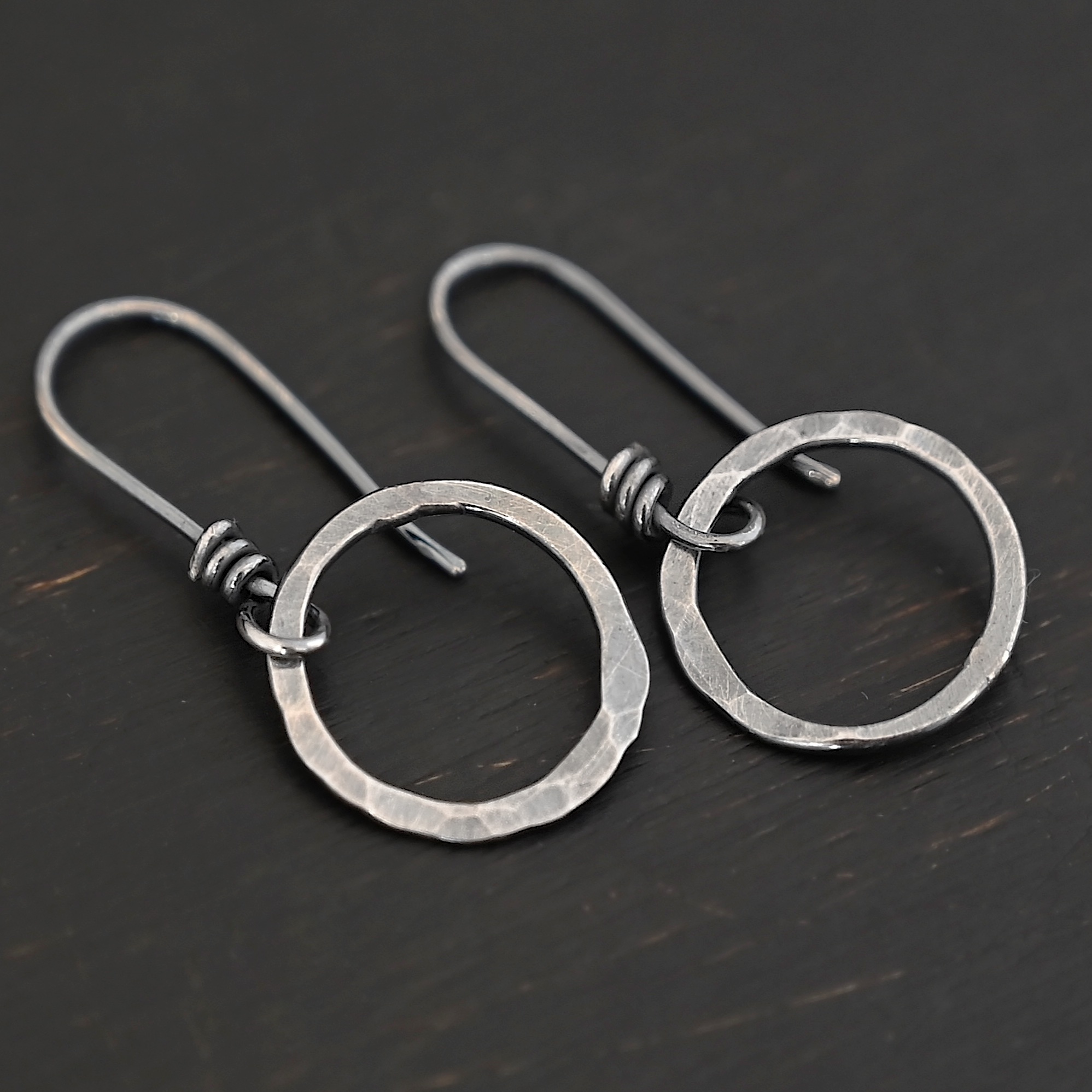 Sterling Silver Flora Hammered Circle Earrings oxidized shown on dark background