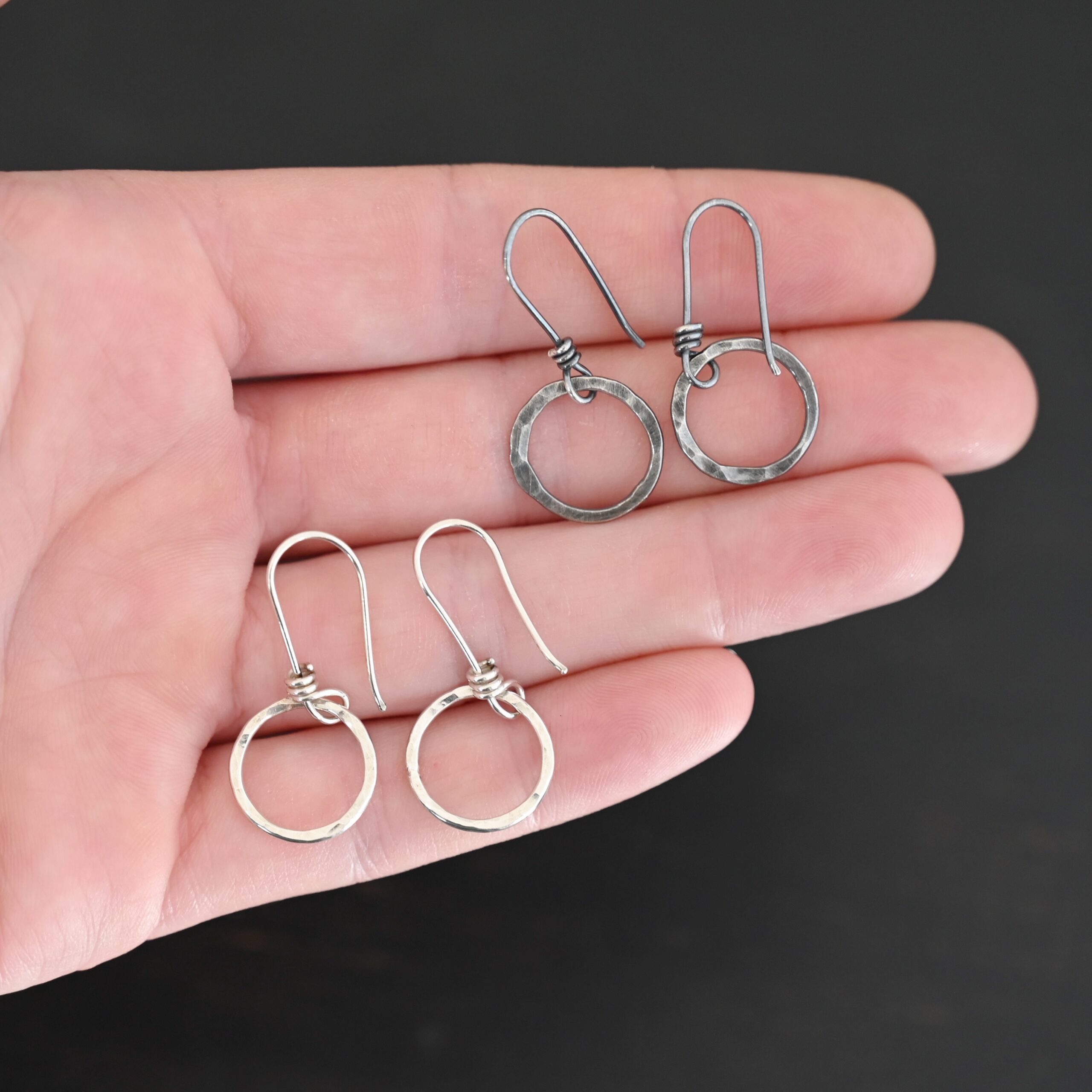 Sterling Silver Flora Hammered Circle Earrings oxidized and shiny shown in hand