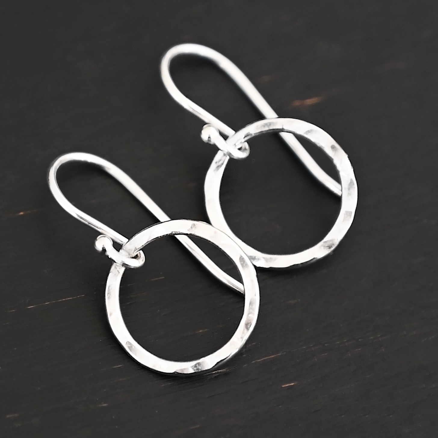 Sterling Silver Fawna Hammered Circle Earrings shiny shown on dark background