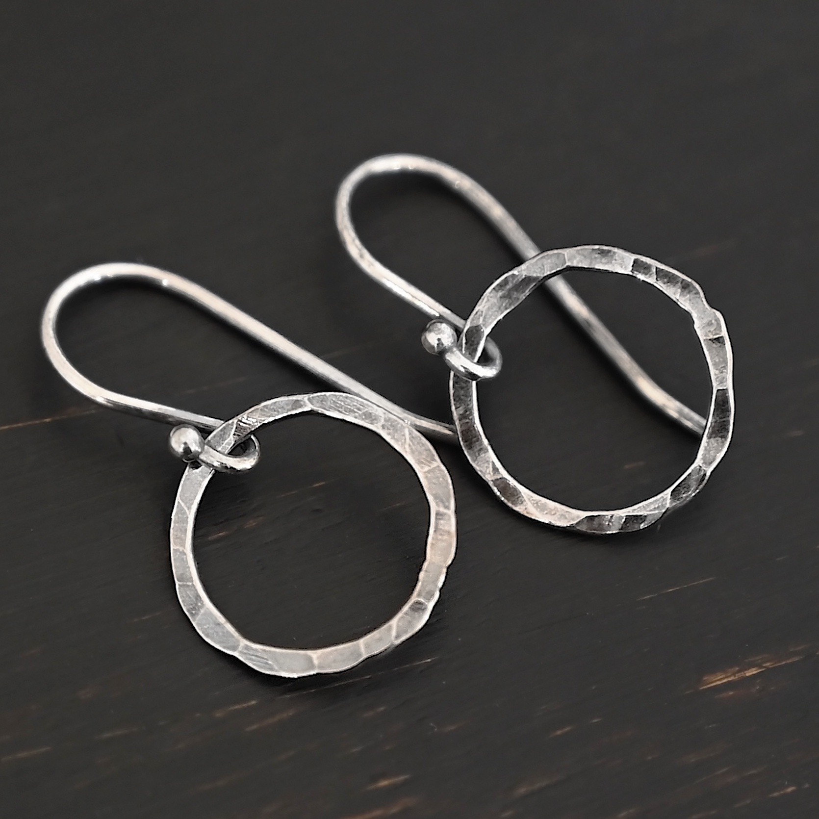 Sterling Silver Fawna Hammered Circle Earrings oxidized shown on dark background