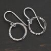 Sterling Silver Fawna Hammered Circle Earrings oxidized shown on dark background