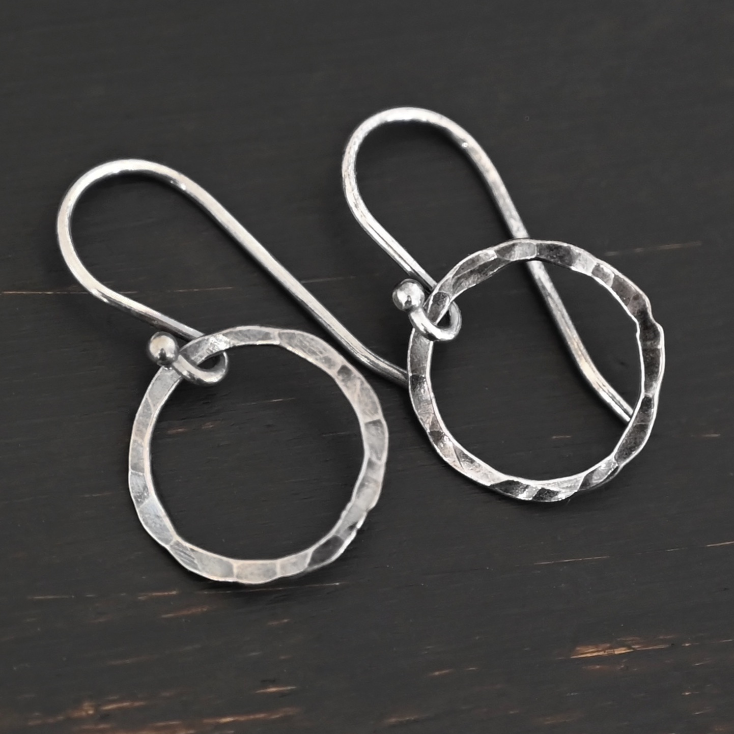 Sterling Silver Fawna Hammered Circle Earrings oxidized shown on dark background