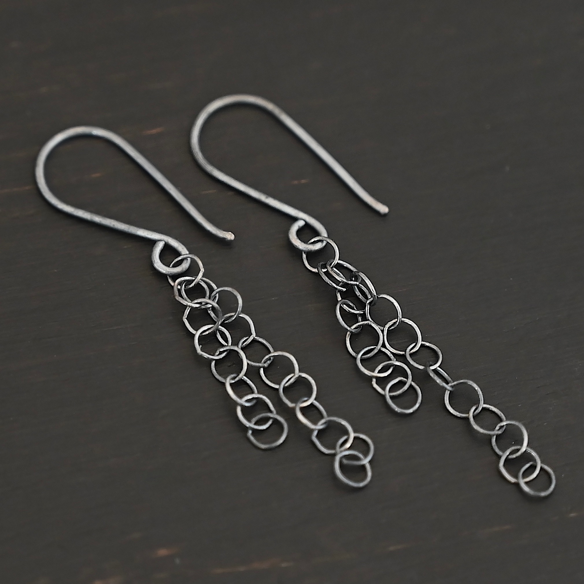 Sterling Silver Florella Dangle Earrings oxidized shown on dark background