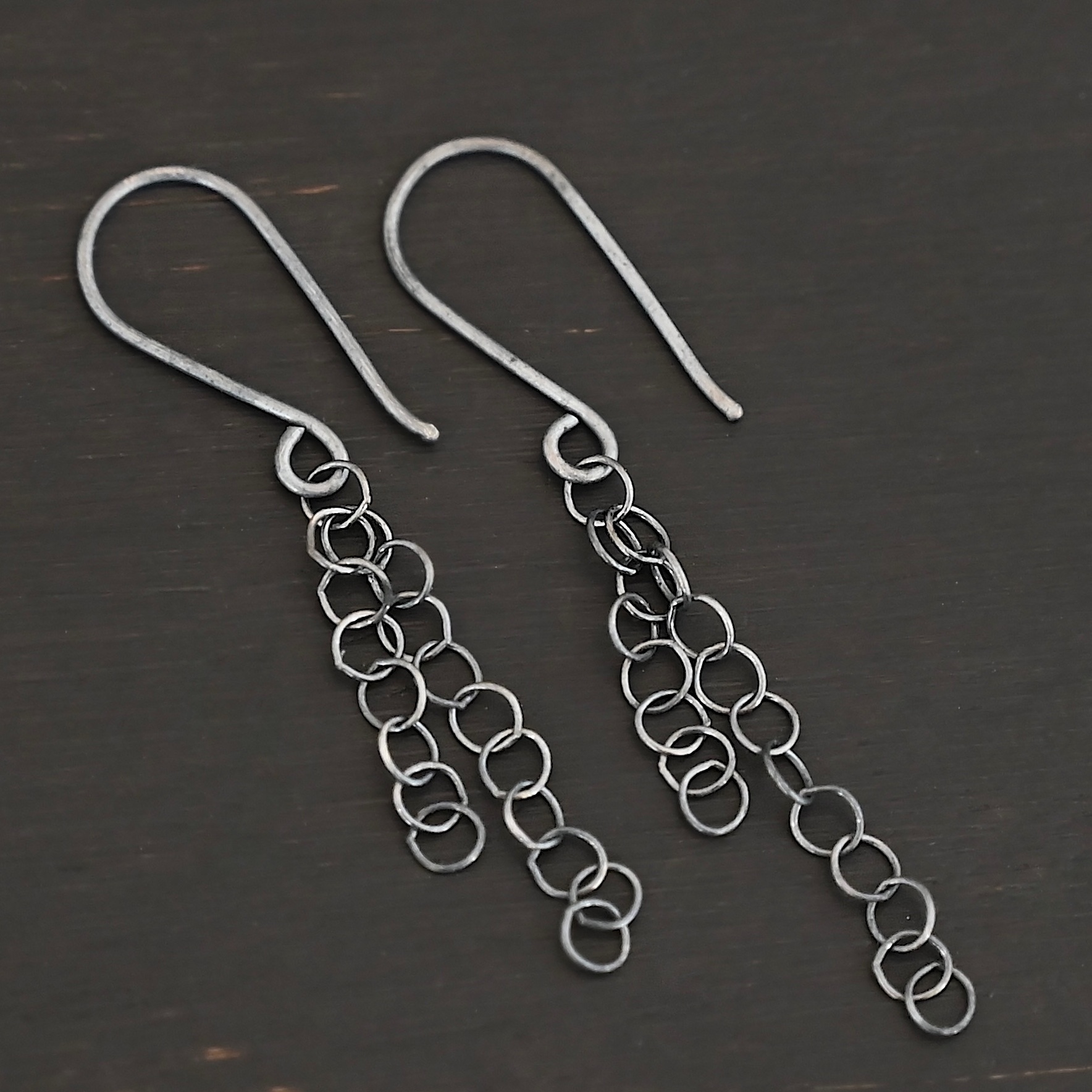 Sterling Silver Florella Dangle Earrings oxidized shown on dark background