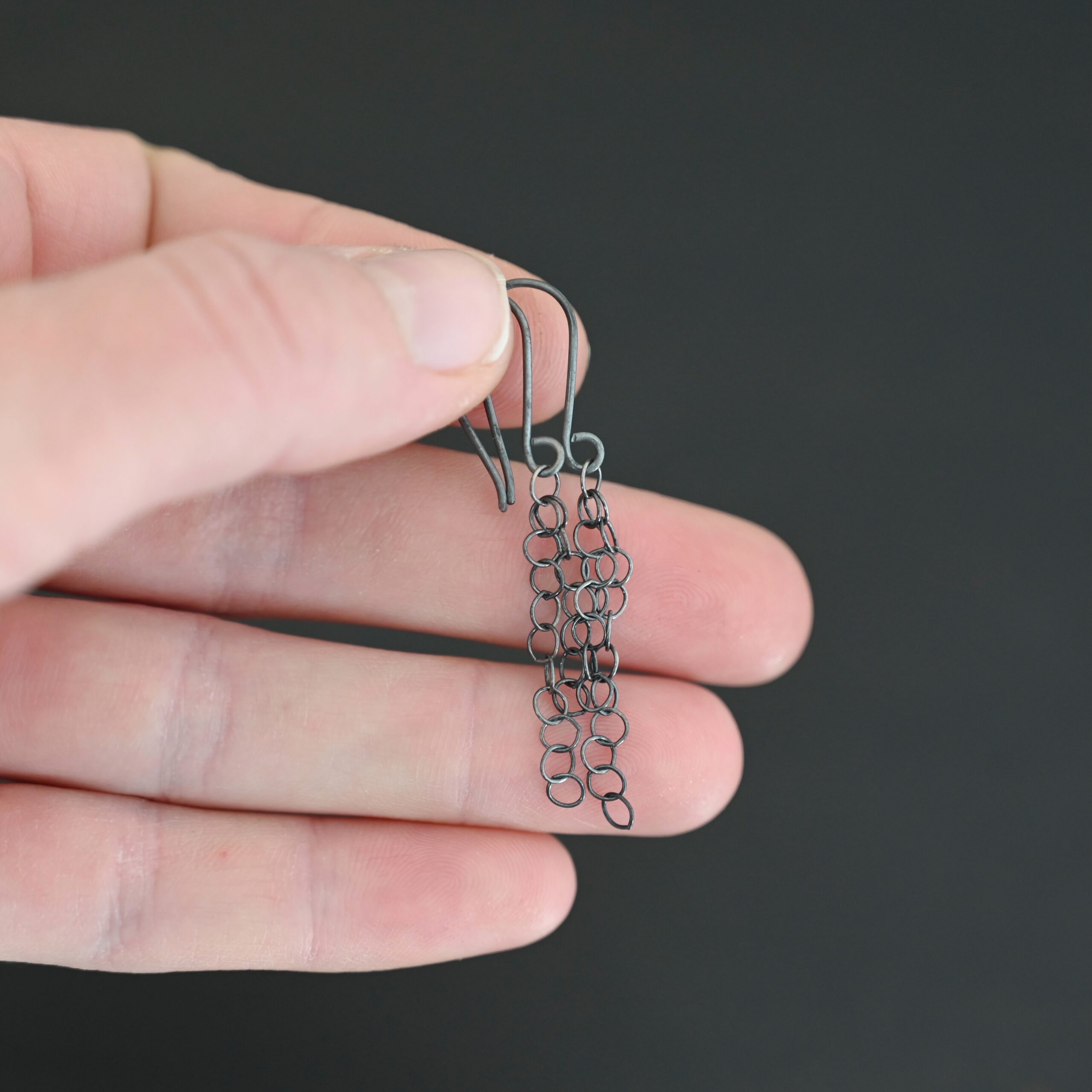 Sterling Silver Florella Dangle Earrings oxidized shown in hand