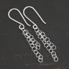Sterling Silver Florella Dangle Earrings shiny shown on dark background