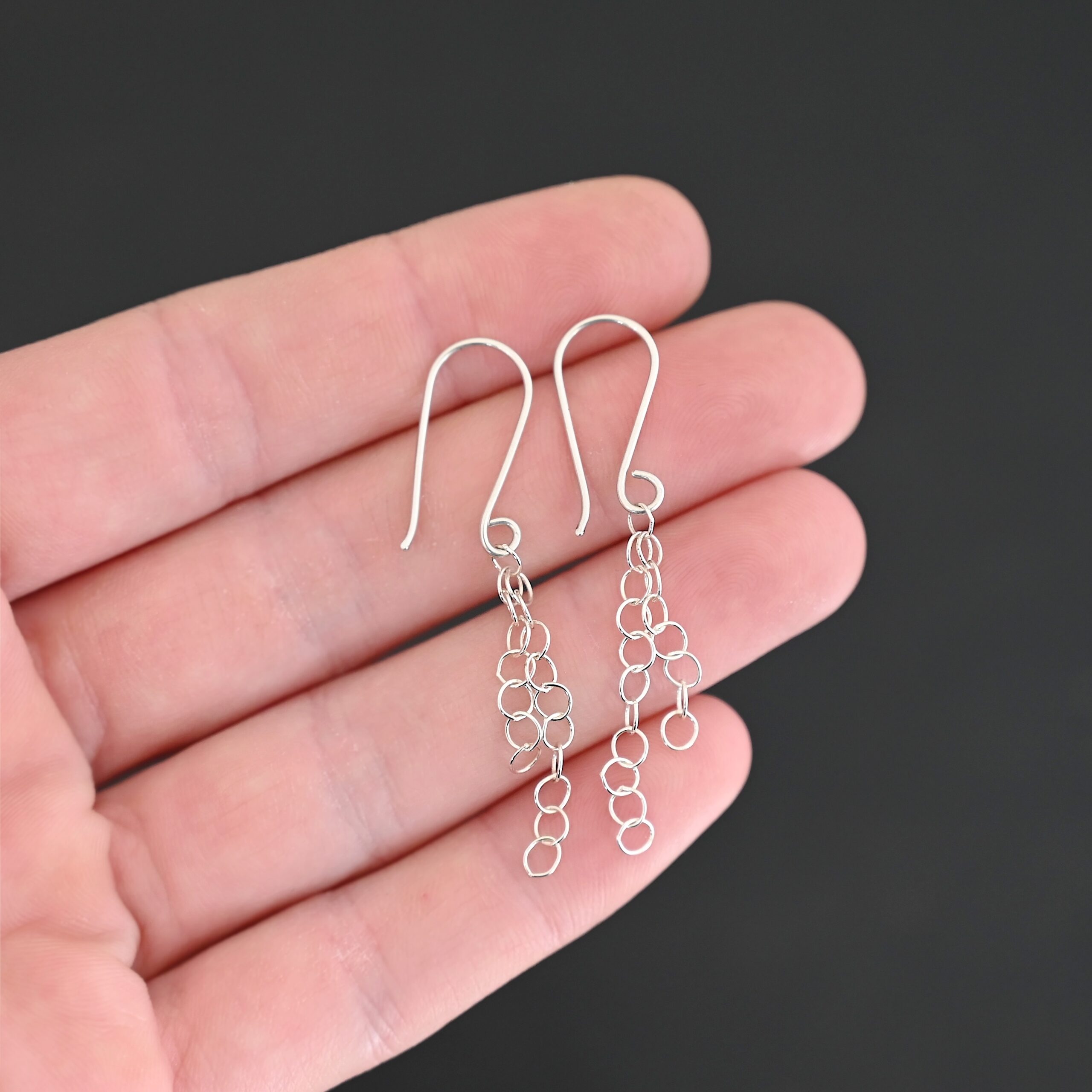 Sterling Silver Florella Dangle Earrings shiny shown in hand
