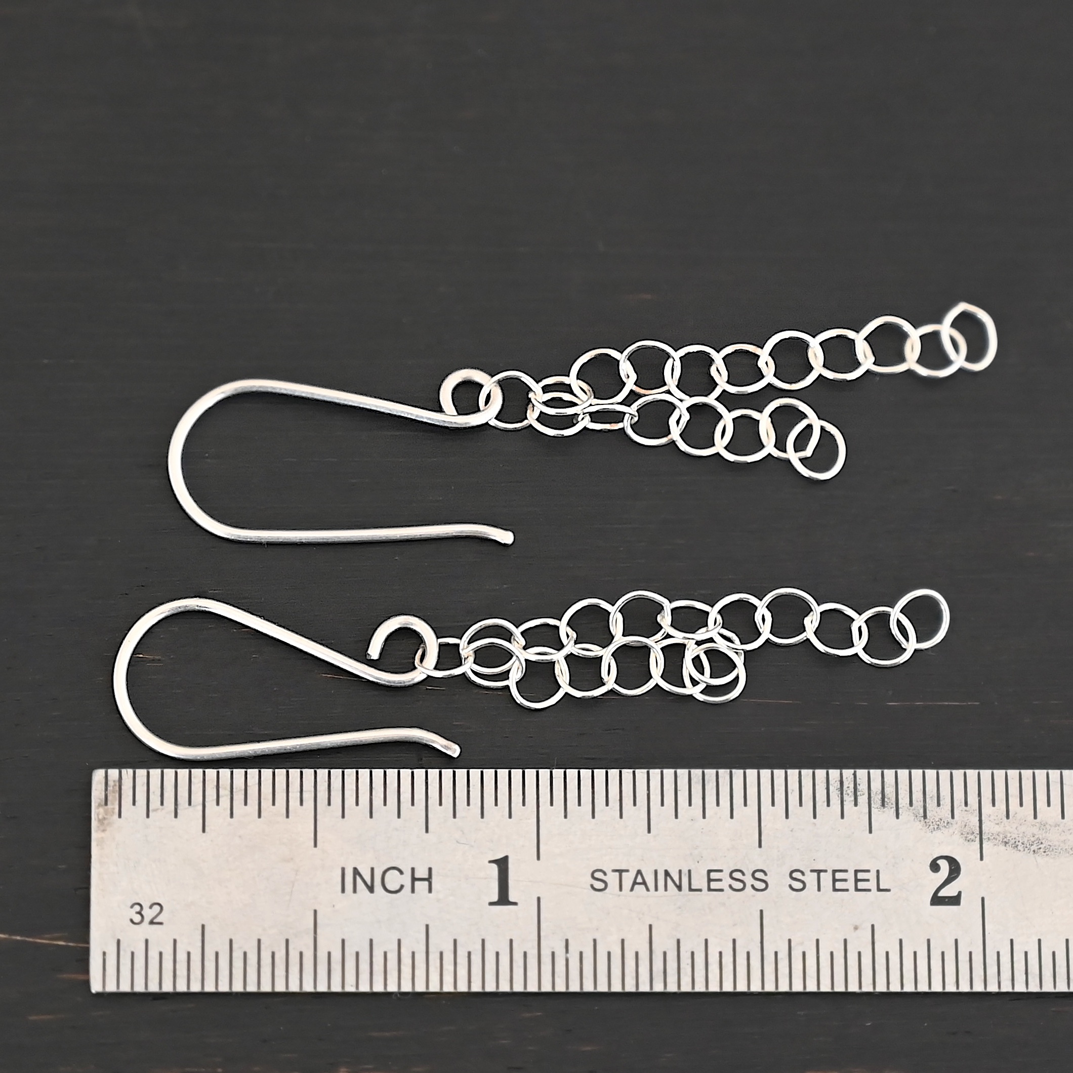 Sterling Silver Florella Dangle Earrings shiny shown by ruler