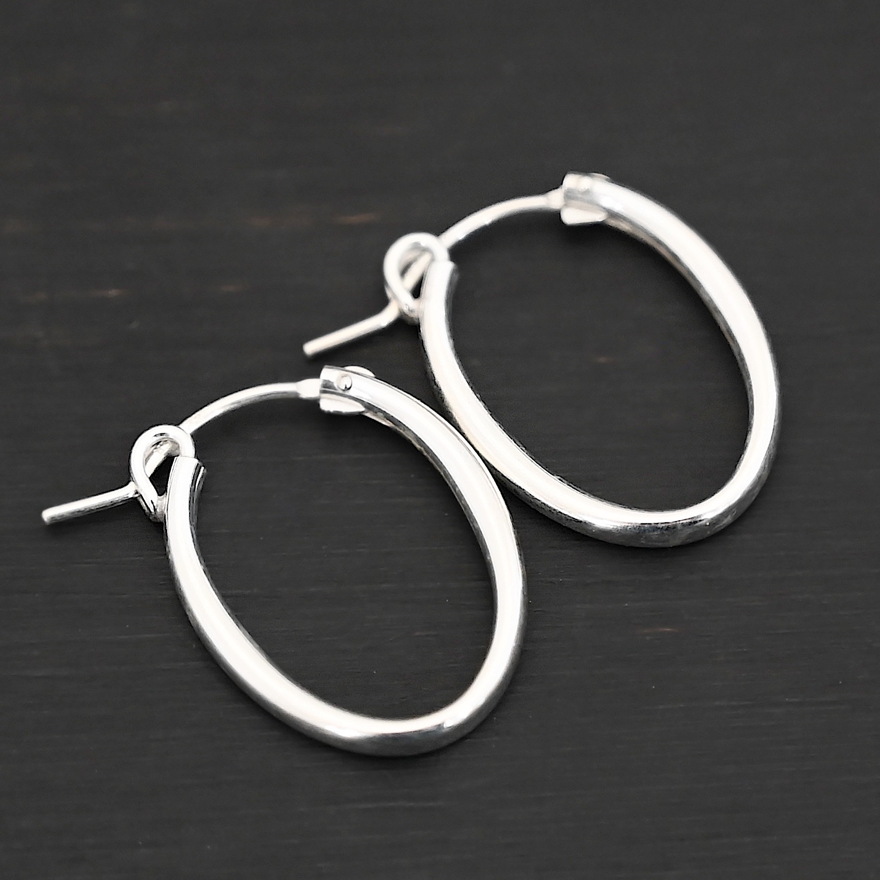 Sterling Silver Frances Oval Hoop Earring 22mm shown on dark background