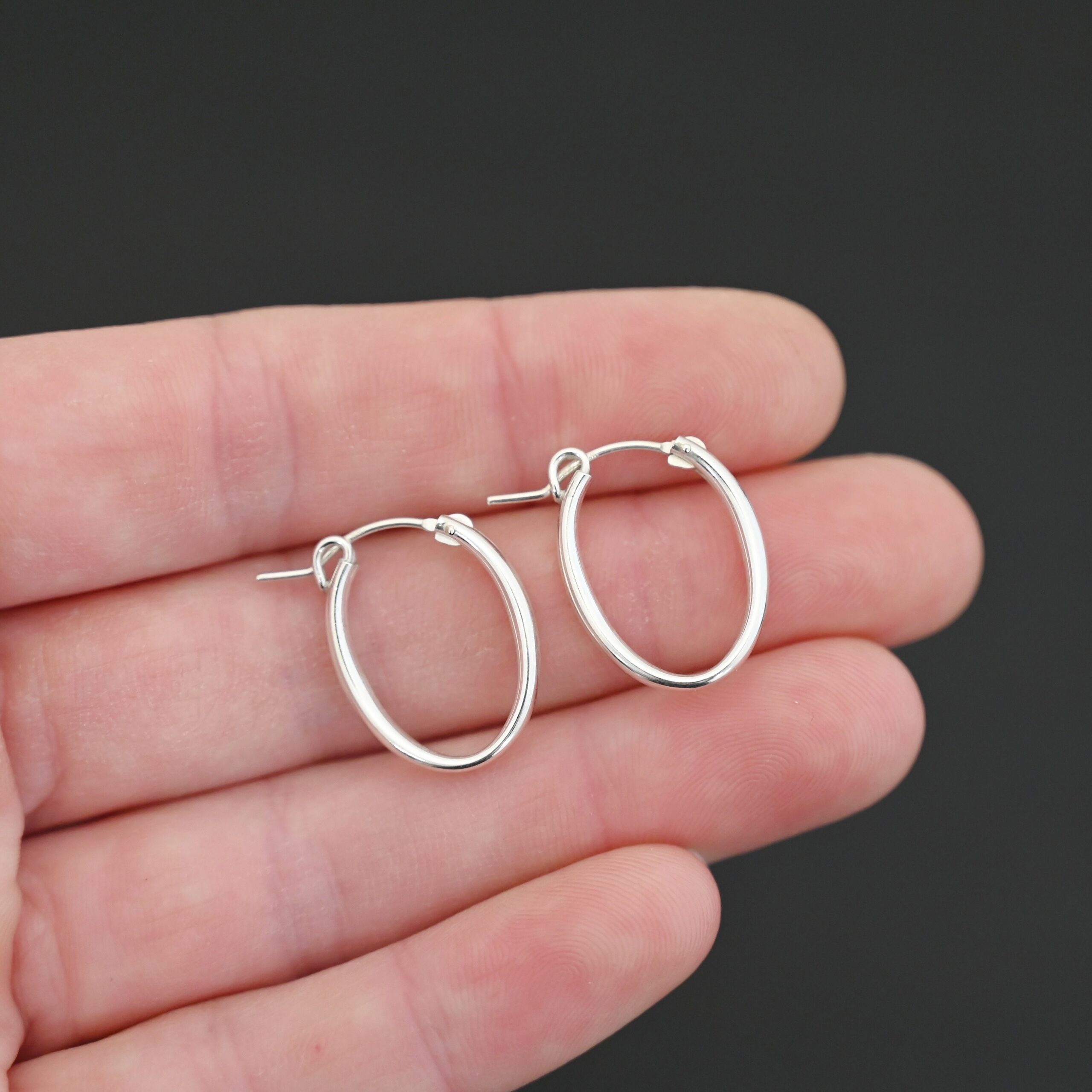Sterling Silver Frances Oval Hoop Earring 22mm shown in hand