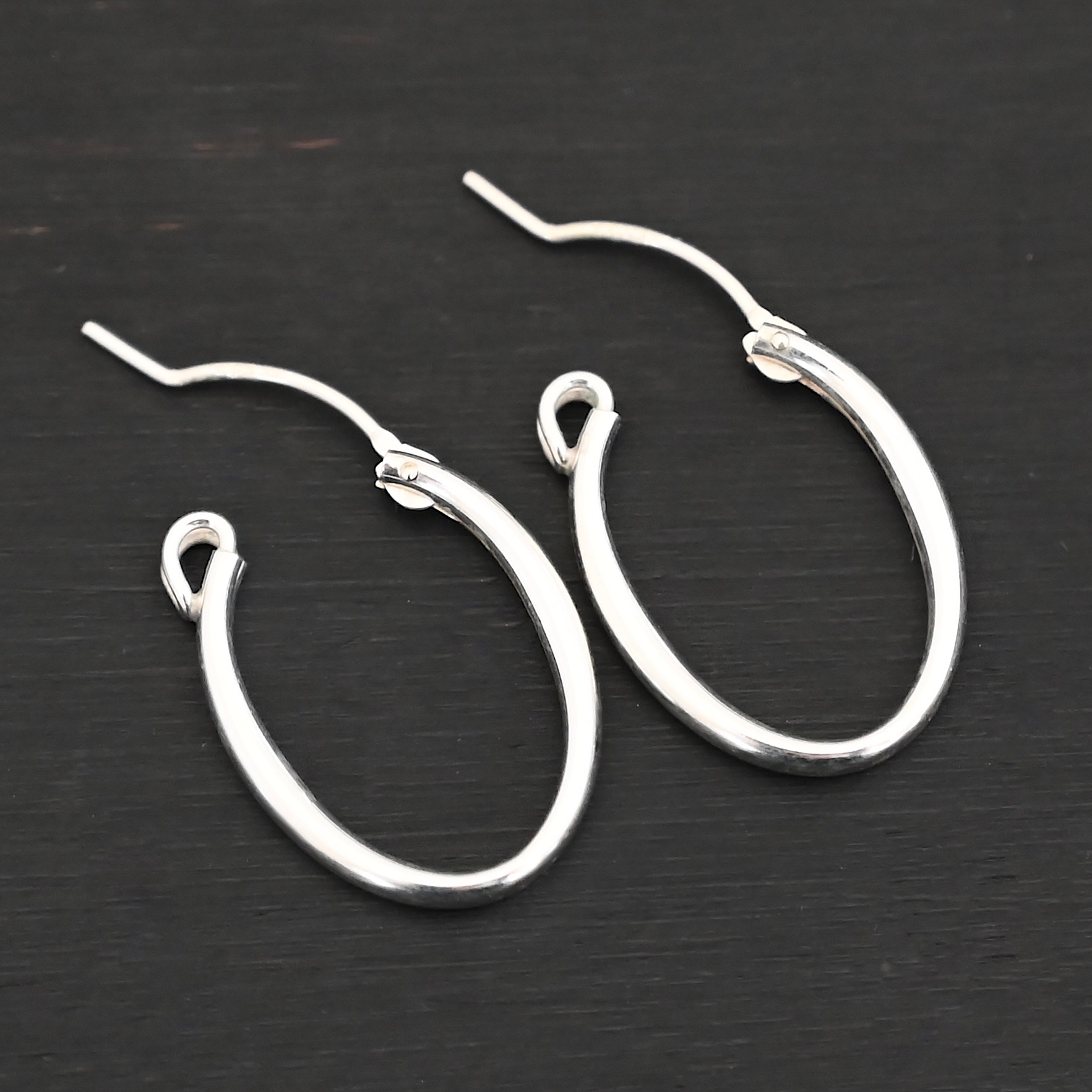 Sterling Silver Frances Oval Hoop Earring 22mm shown on dark background