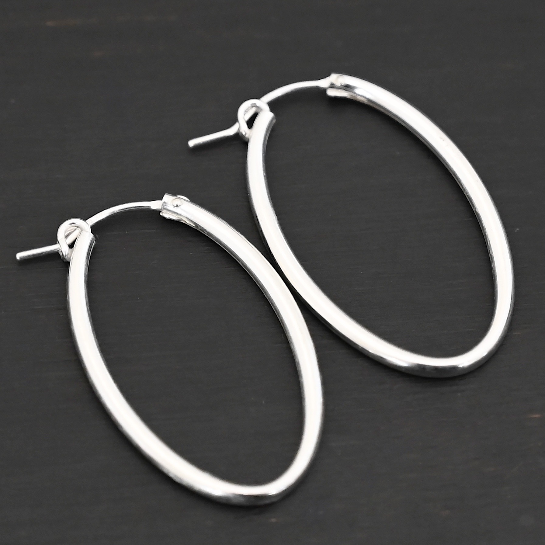 Sterling Silver Frances Oval Hoop Earring 34mm shown on dark background