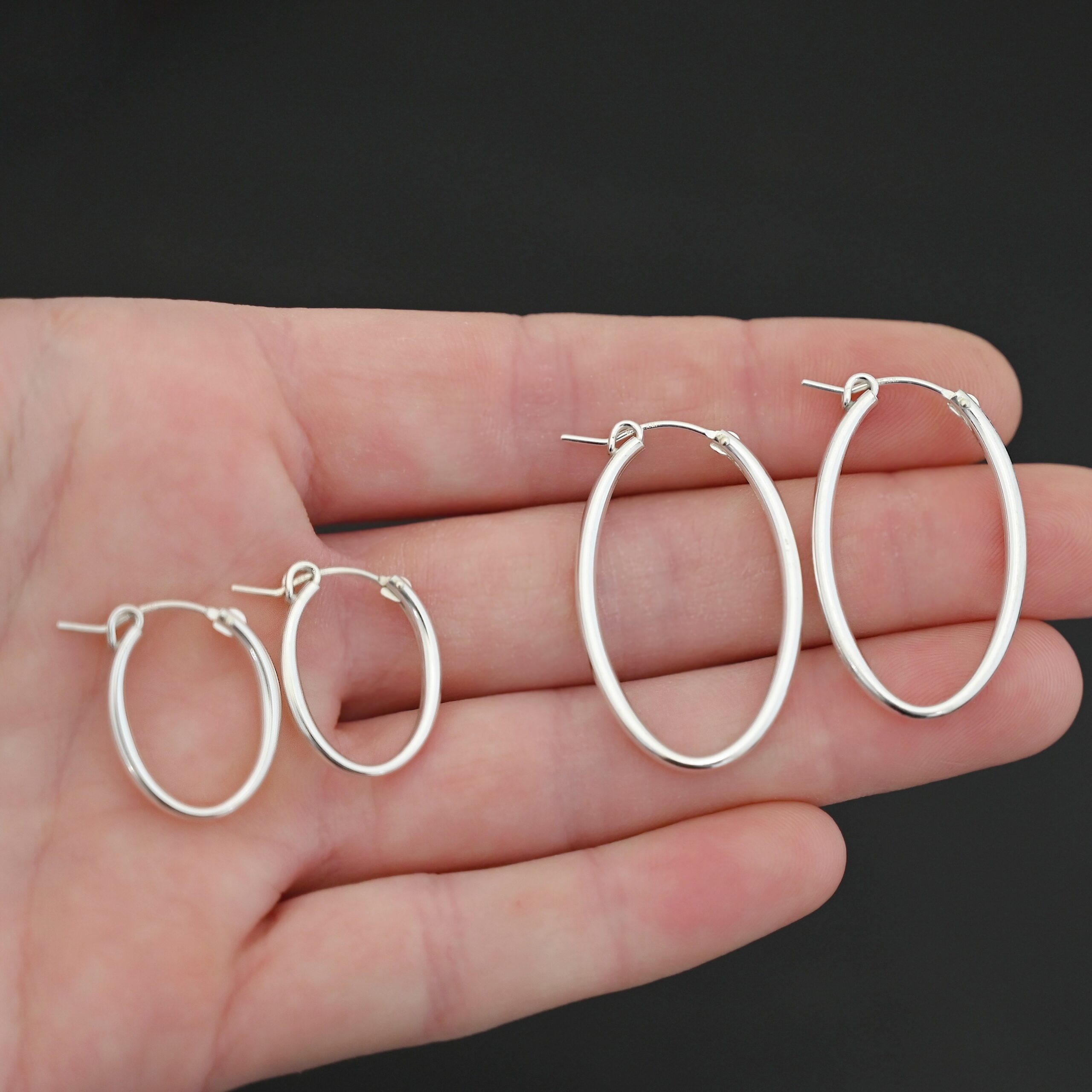 Sterling Silver Frances Oval Hoop Earring 22mm and 34mm shown in hand