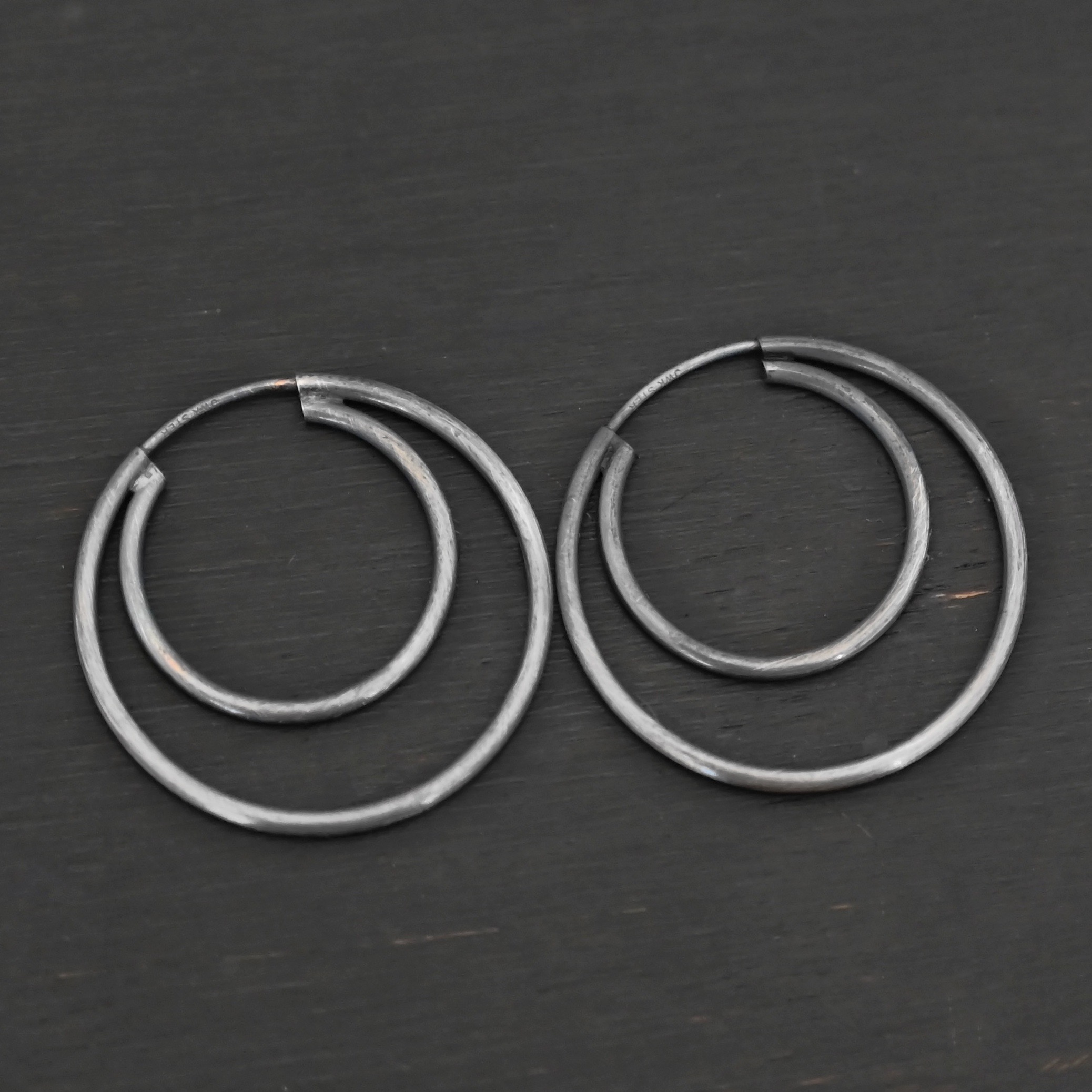 Sterling Silver Fern Double Hoop Earrings oxidized shown on dark background