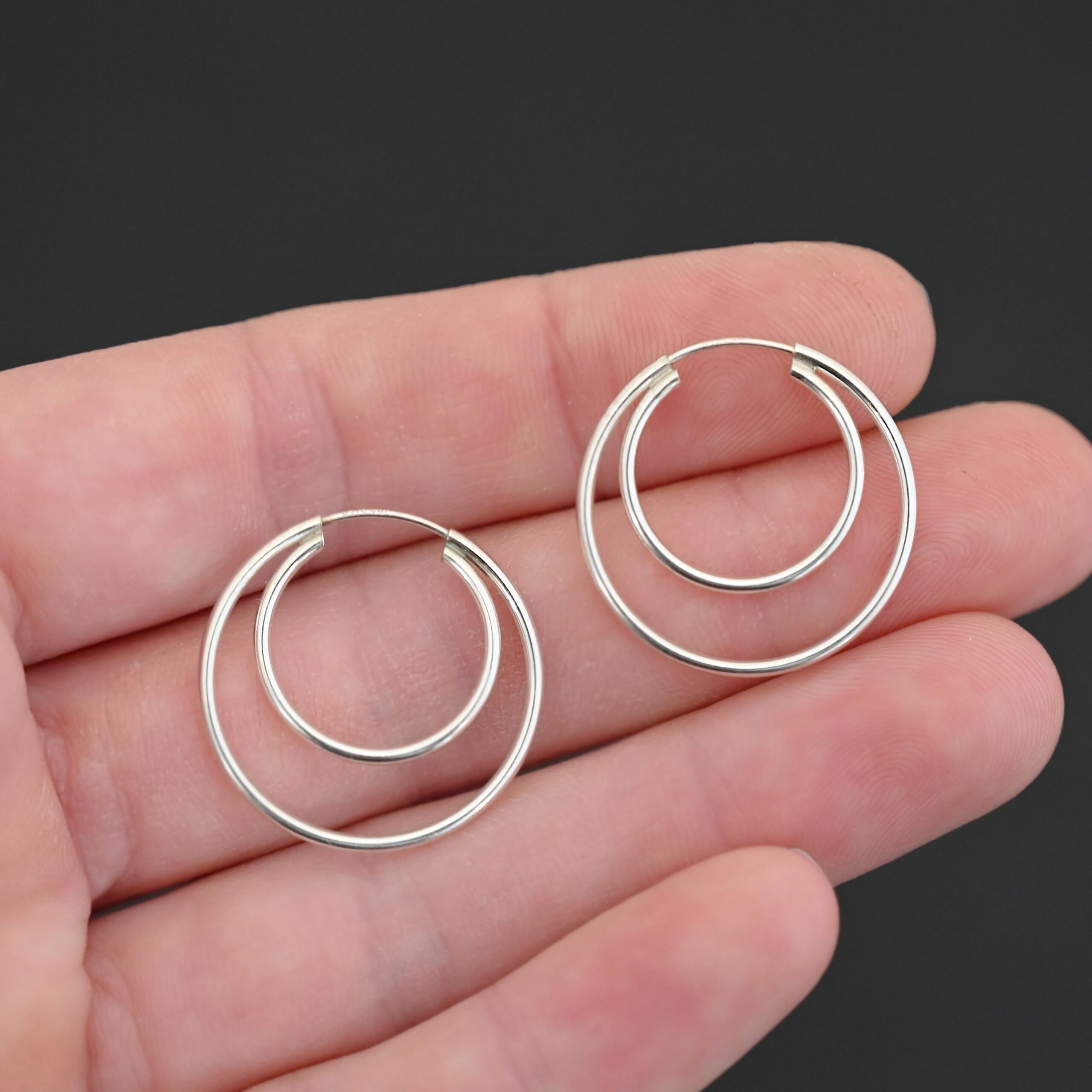 Sterling Silver Fern Double Hoop Earrings 25mm shiny shown in hand