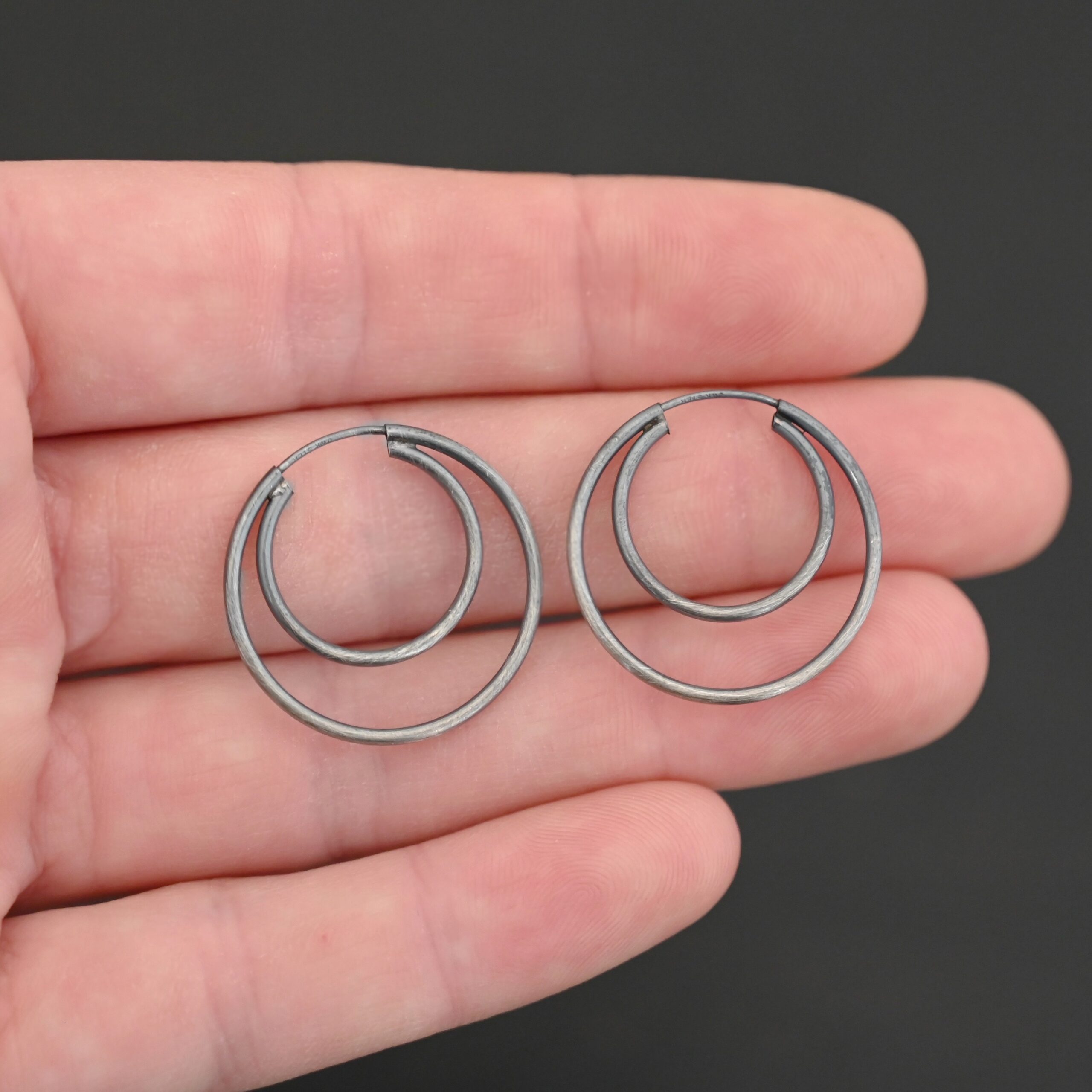 Sterling Silver Fern Double Hoop Earrings 25mm oxidized shown in hand