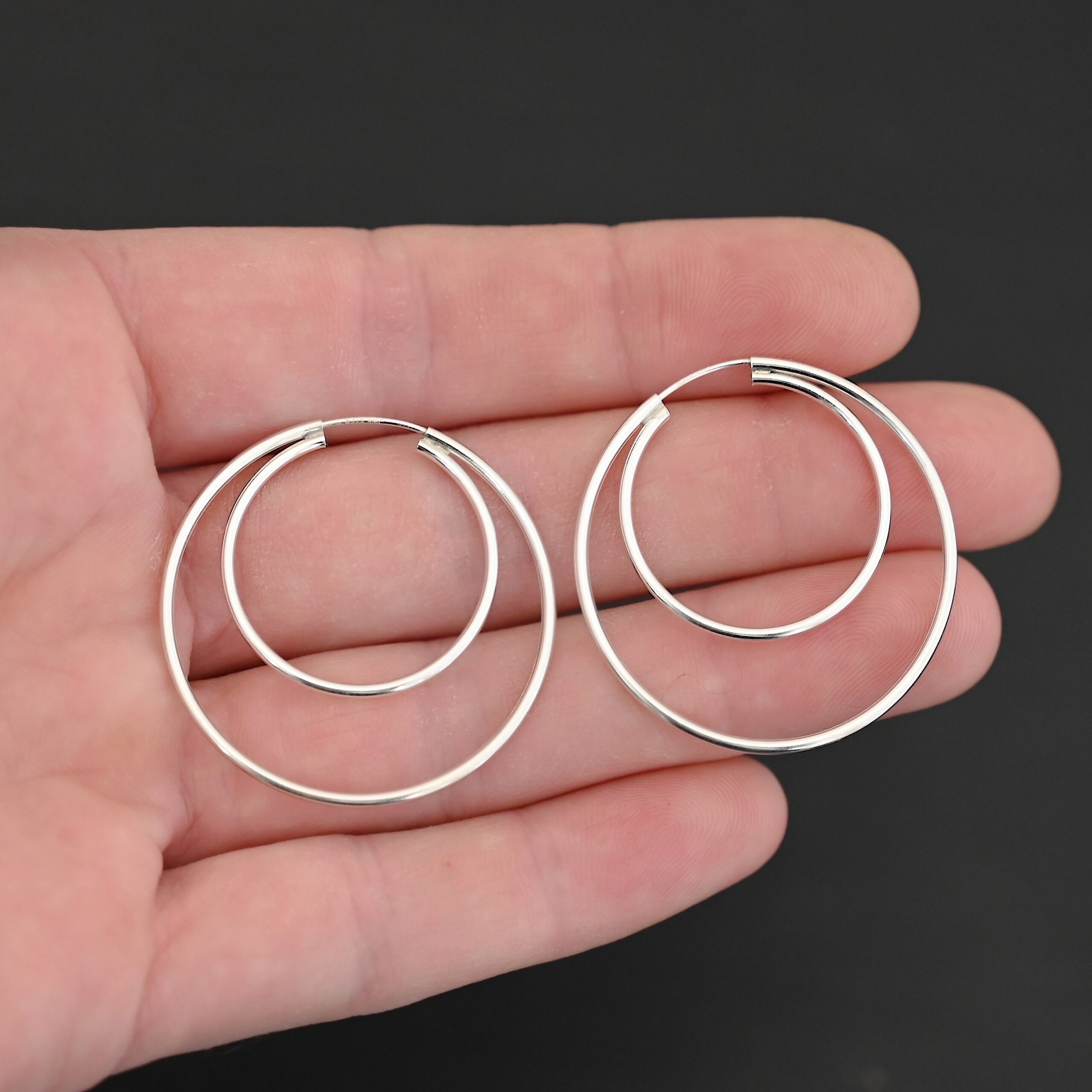 Sterling Silver Fern Double Hoop Earrings 35mm shiny shown in hand