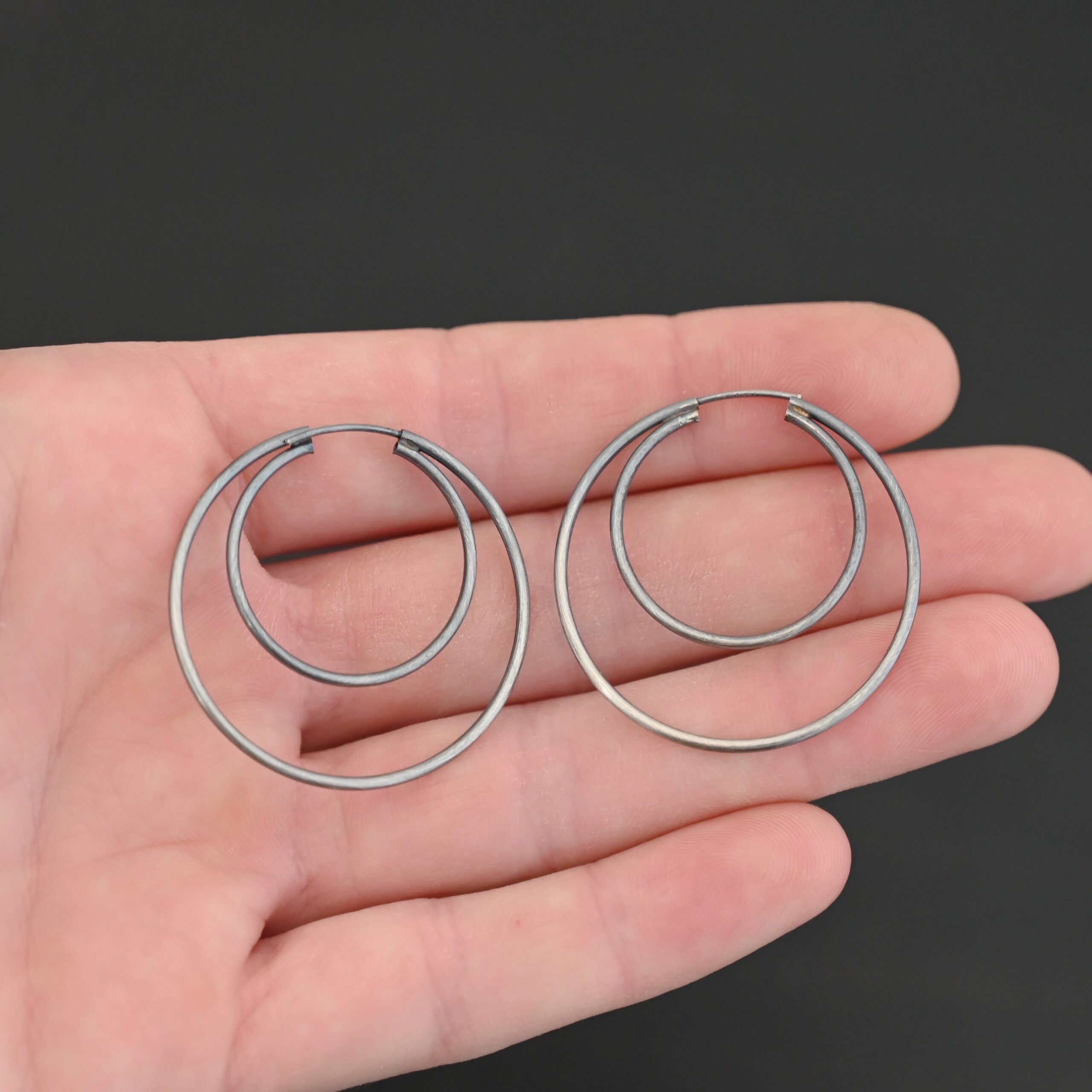 Sterling Silver Fern Double Hoop Earrings 35mm oxidized shown in hand