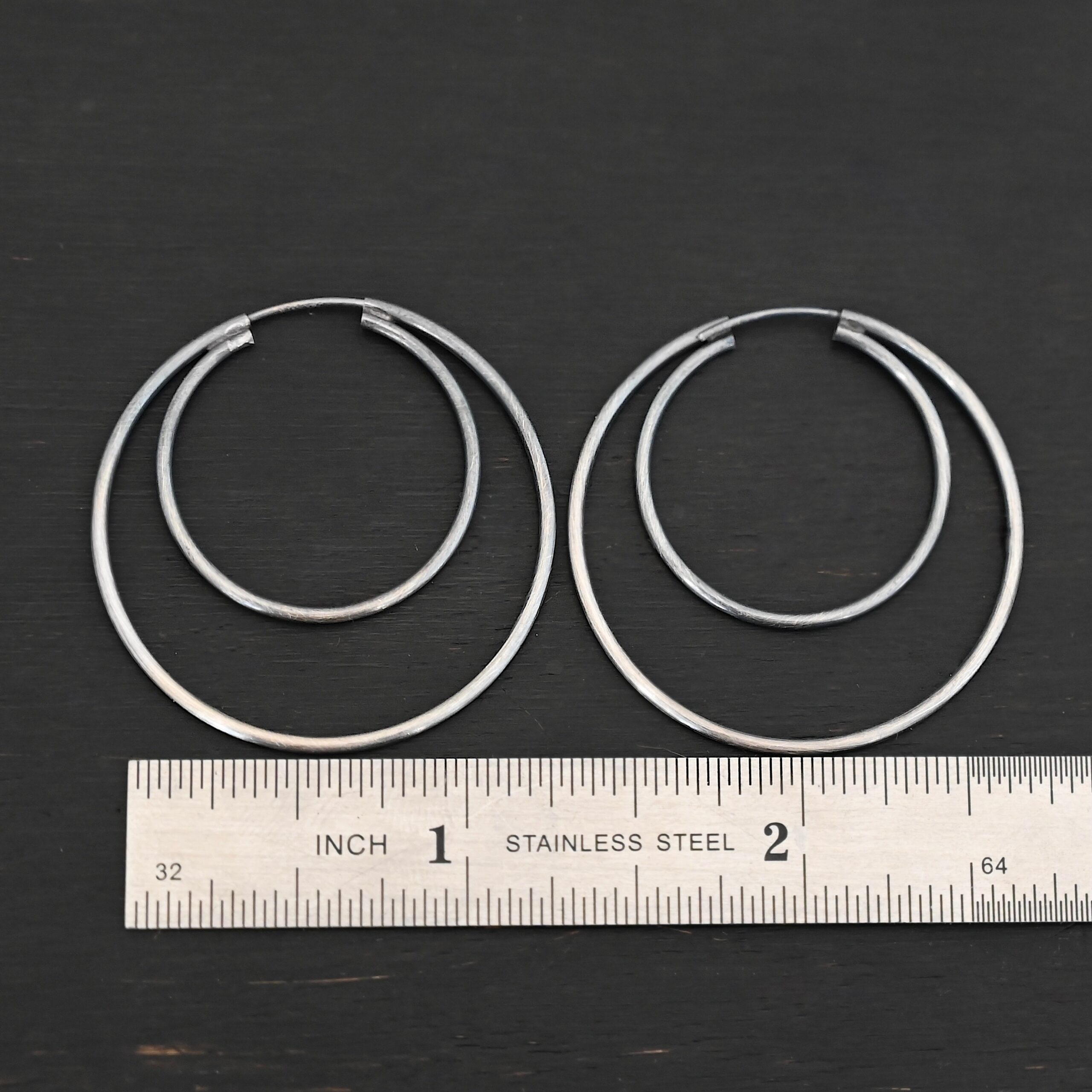 Sterling Silver Fern Double Hoop Earrings 35mm oxidized shown by ruler