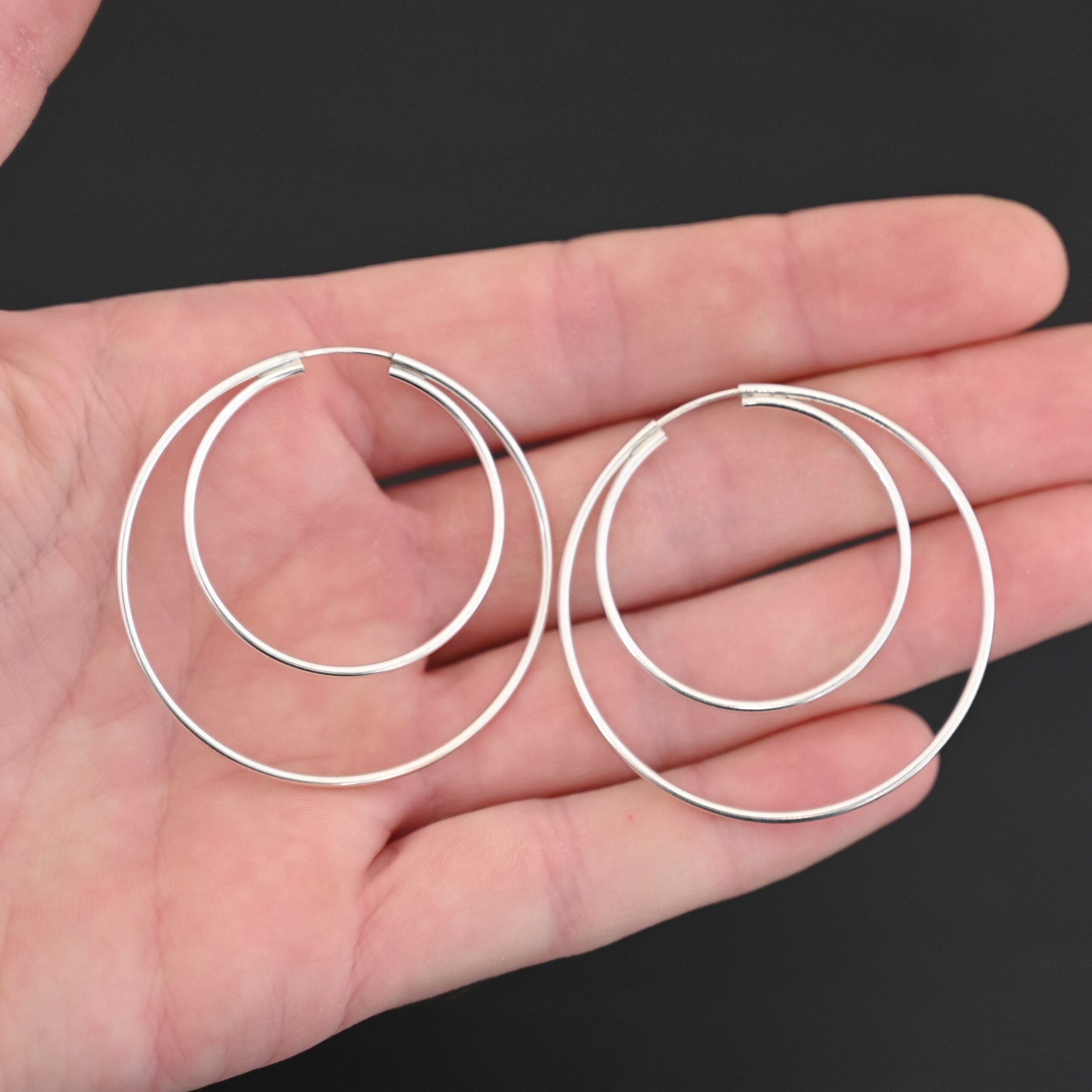 Sterling Silver Fern Double Hoop Earrings 45mm shiny shown in hand