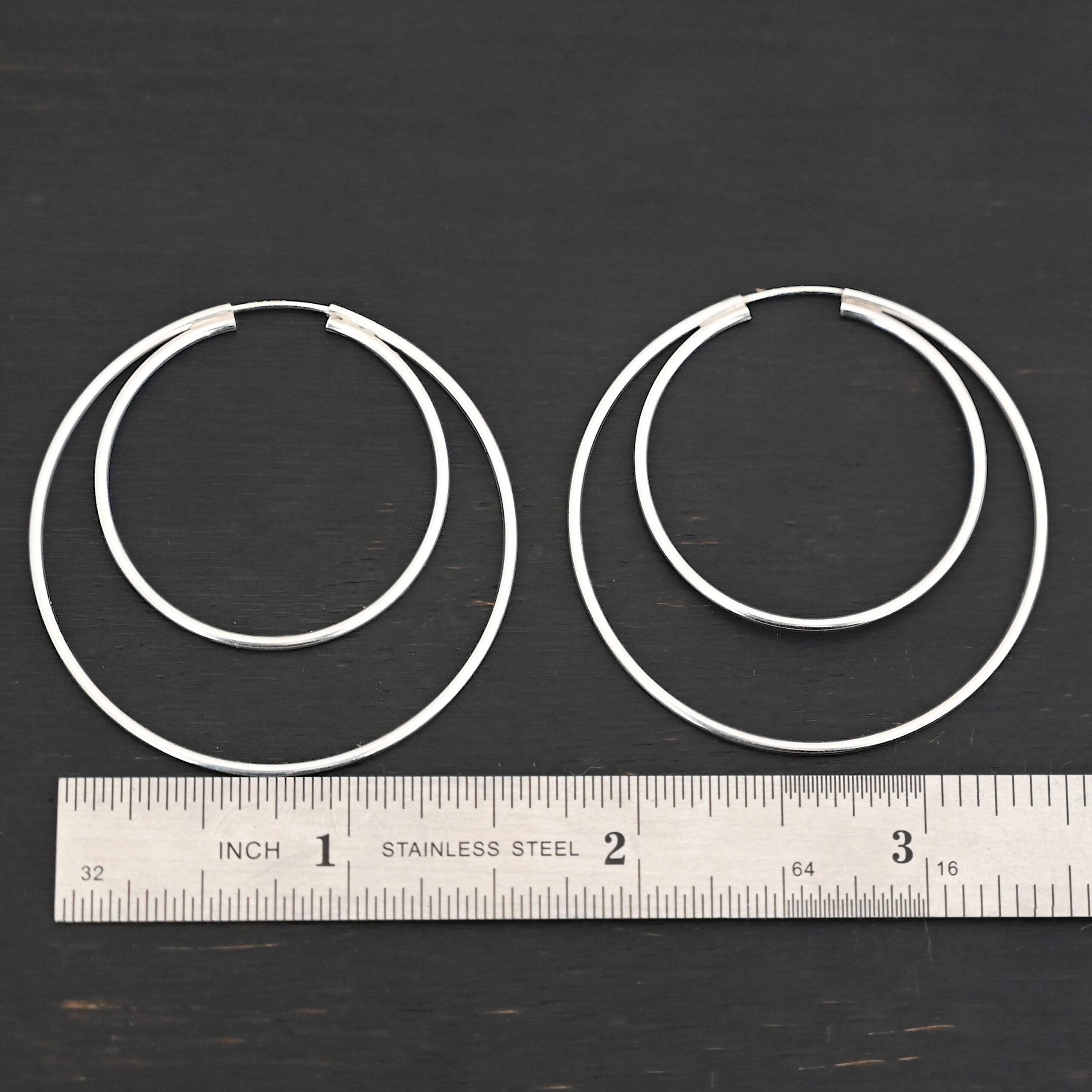 Sterling Silver Fern Double Hoop Earrings 45mm shiny shown by ruler