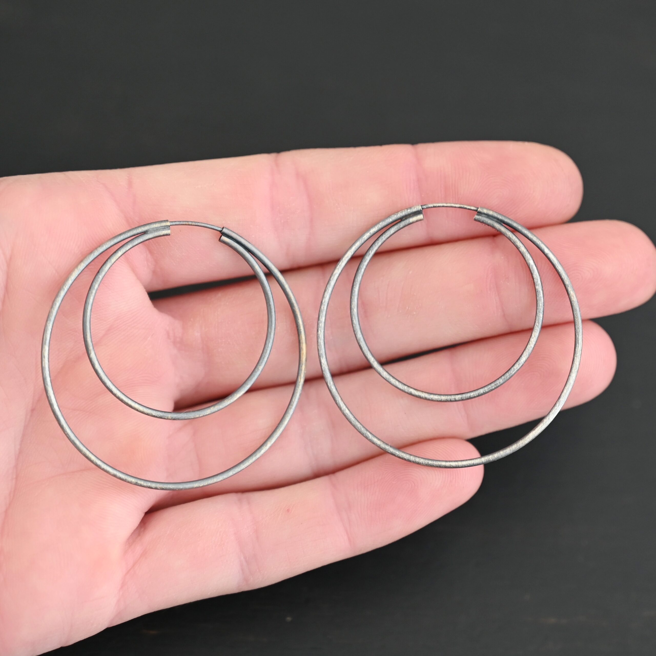 Sterling Silver Fern Double Hoop Earrings 45mm oxidized shown in hand