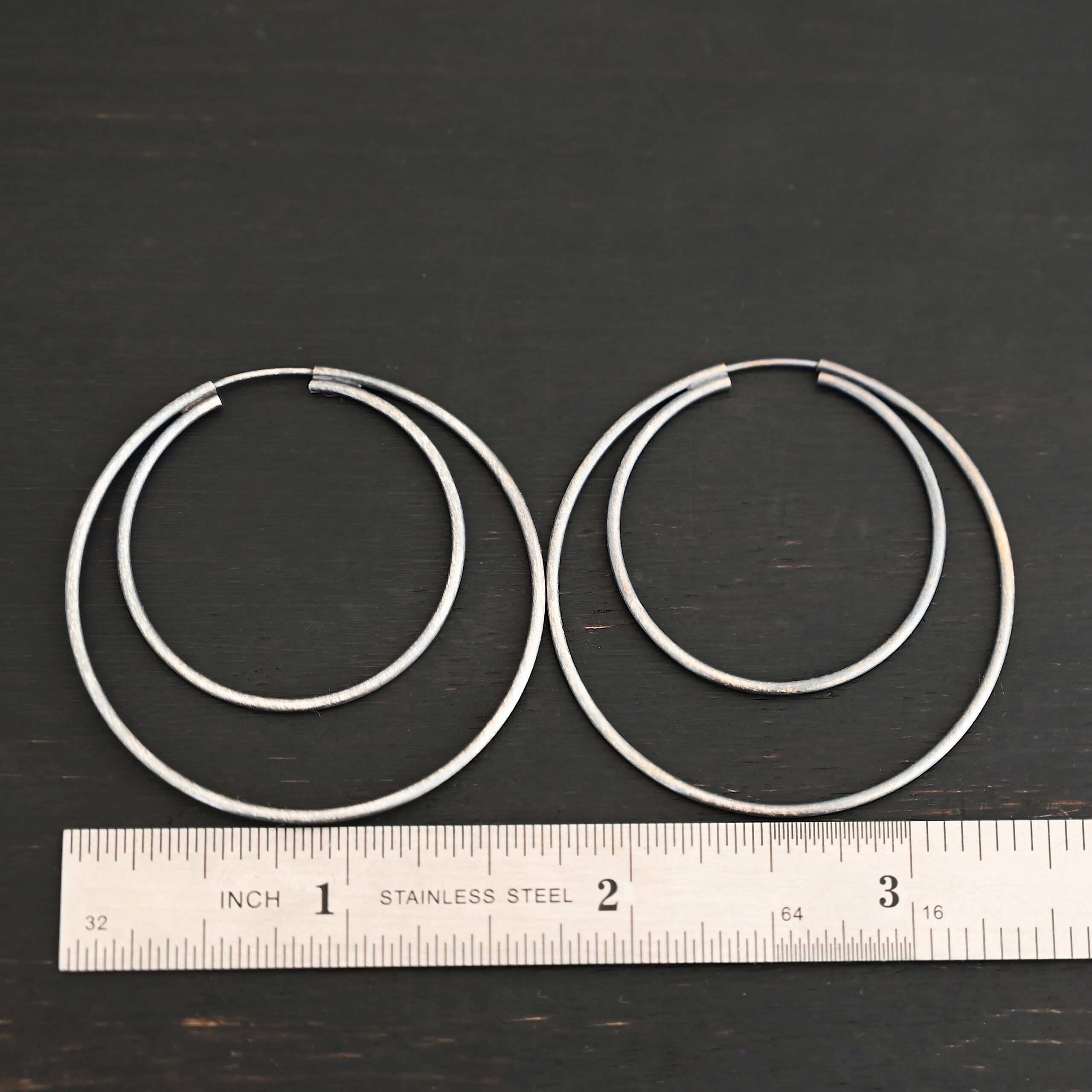 Sterling Silver Fern Double Hoop Earrings 45mm oxidized shown by ruler