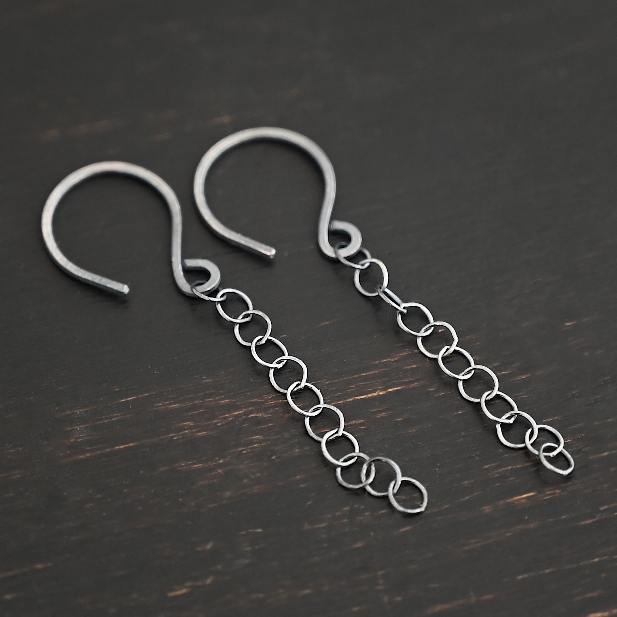 Sterling Silver Fay Dangle Earrings oxidized shown on dark background