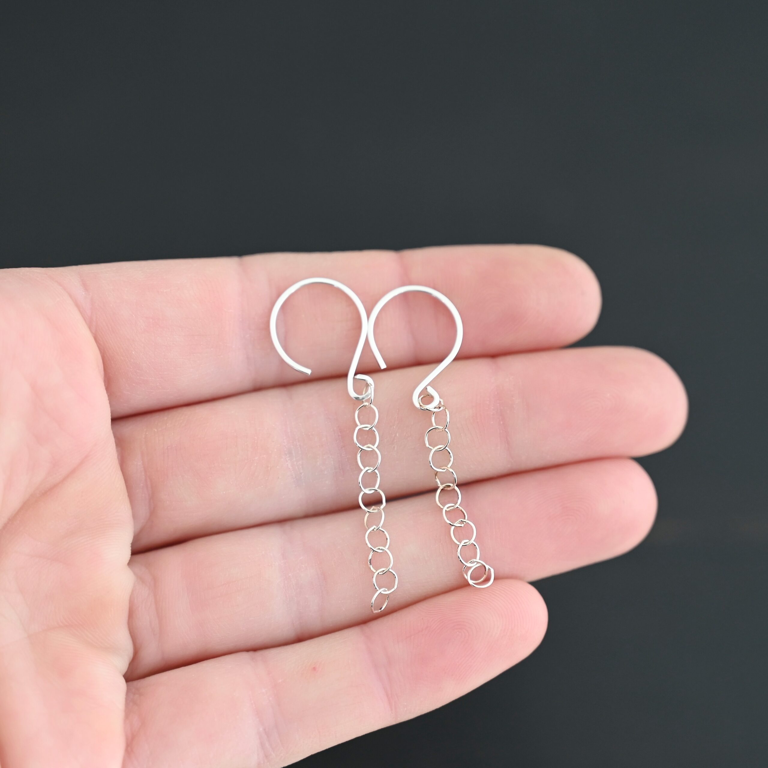 Sterling Silver Fay Dangle Earrings shiny shown in hand