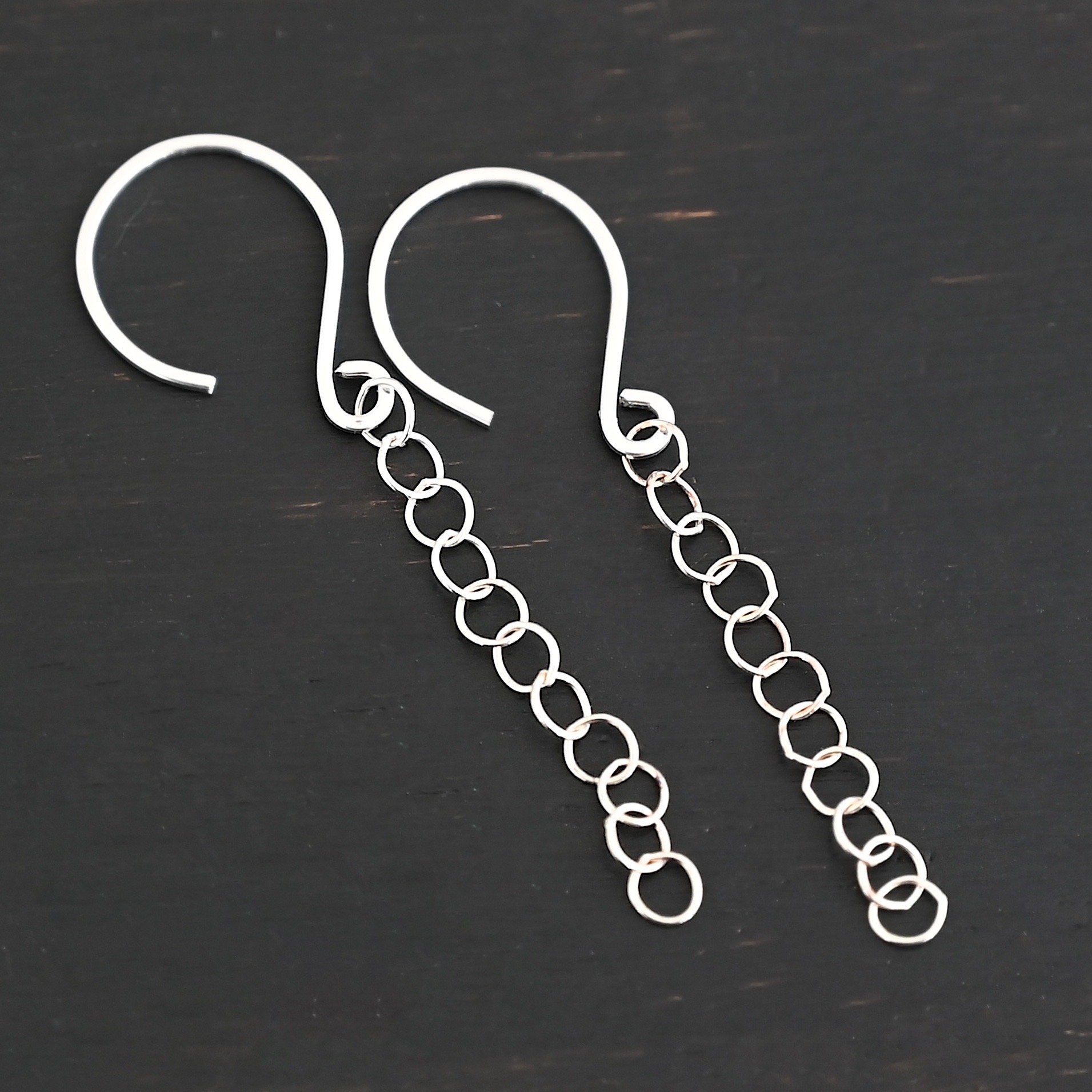Sterling Silver Fay Dangle Earrings shiny shown on dark background