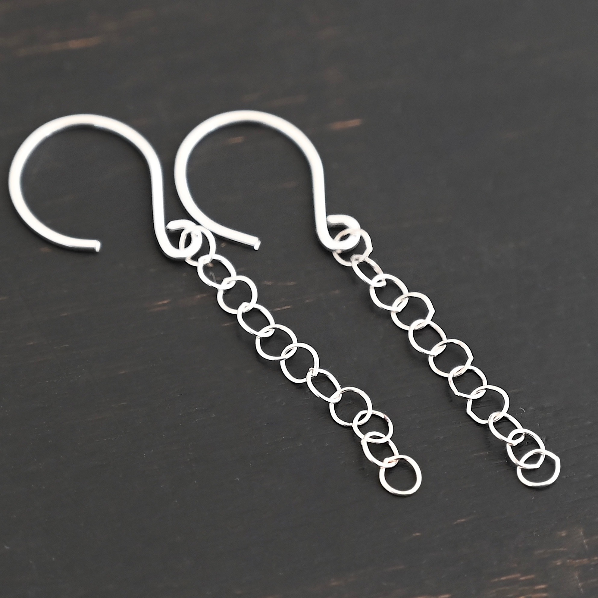 Sterling Silver Fay Dangle Earrings shiny shown on dark background