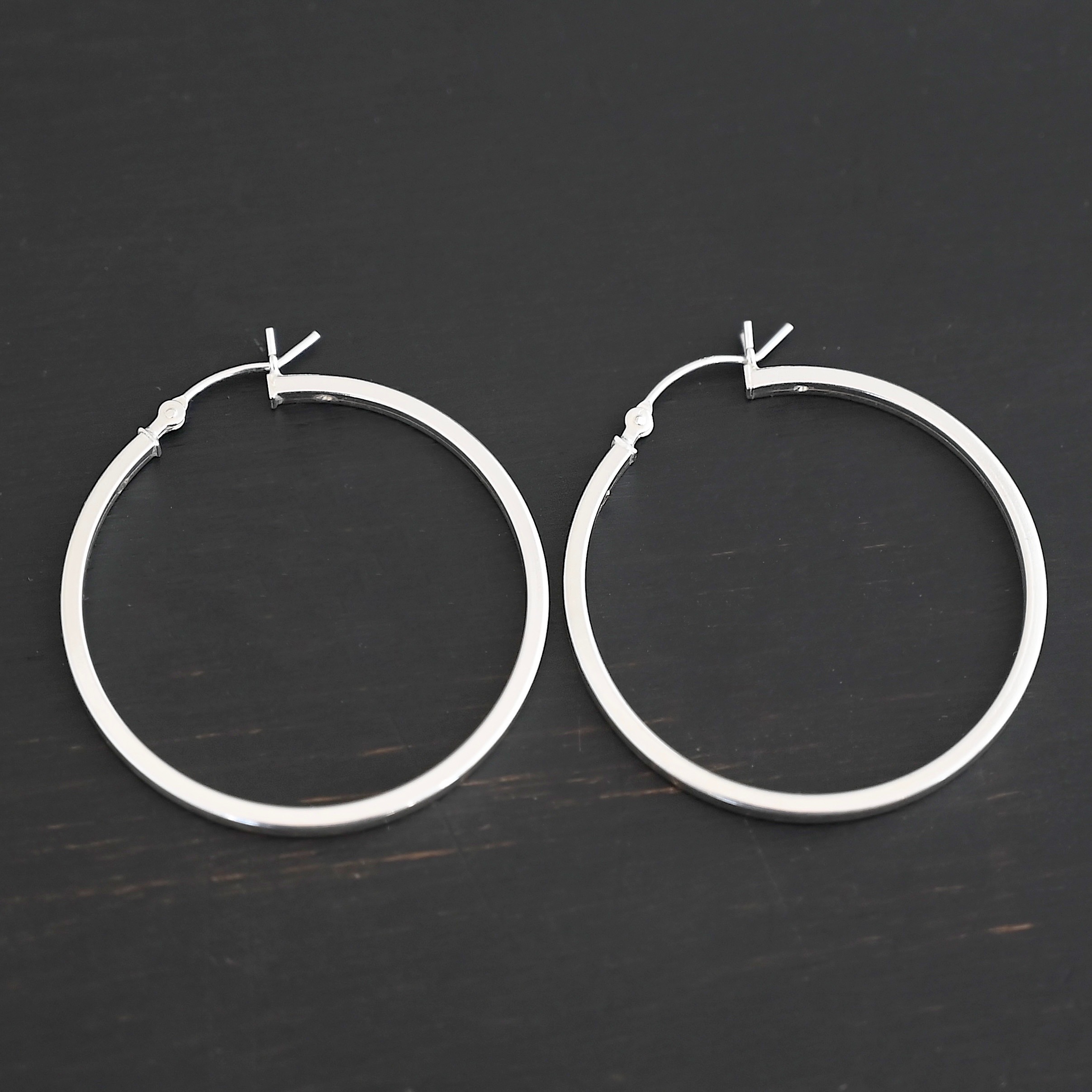 Sterling Silver Frankie Square Hoop Earrings 35mm shiny shown on dark background