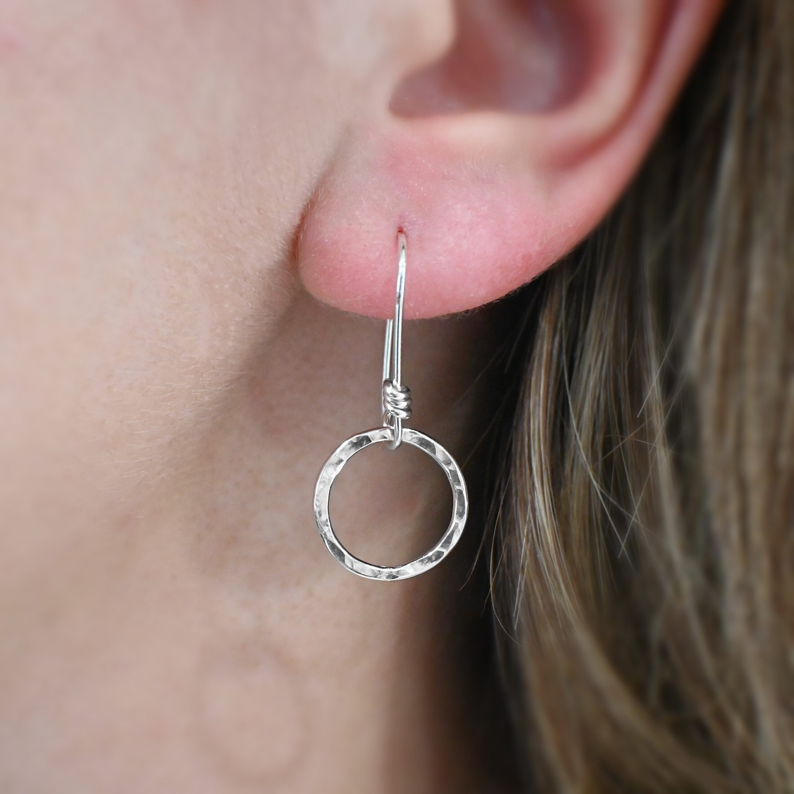 Sterling Silver Flora Hammered Circle Earrings shiny shown on model