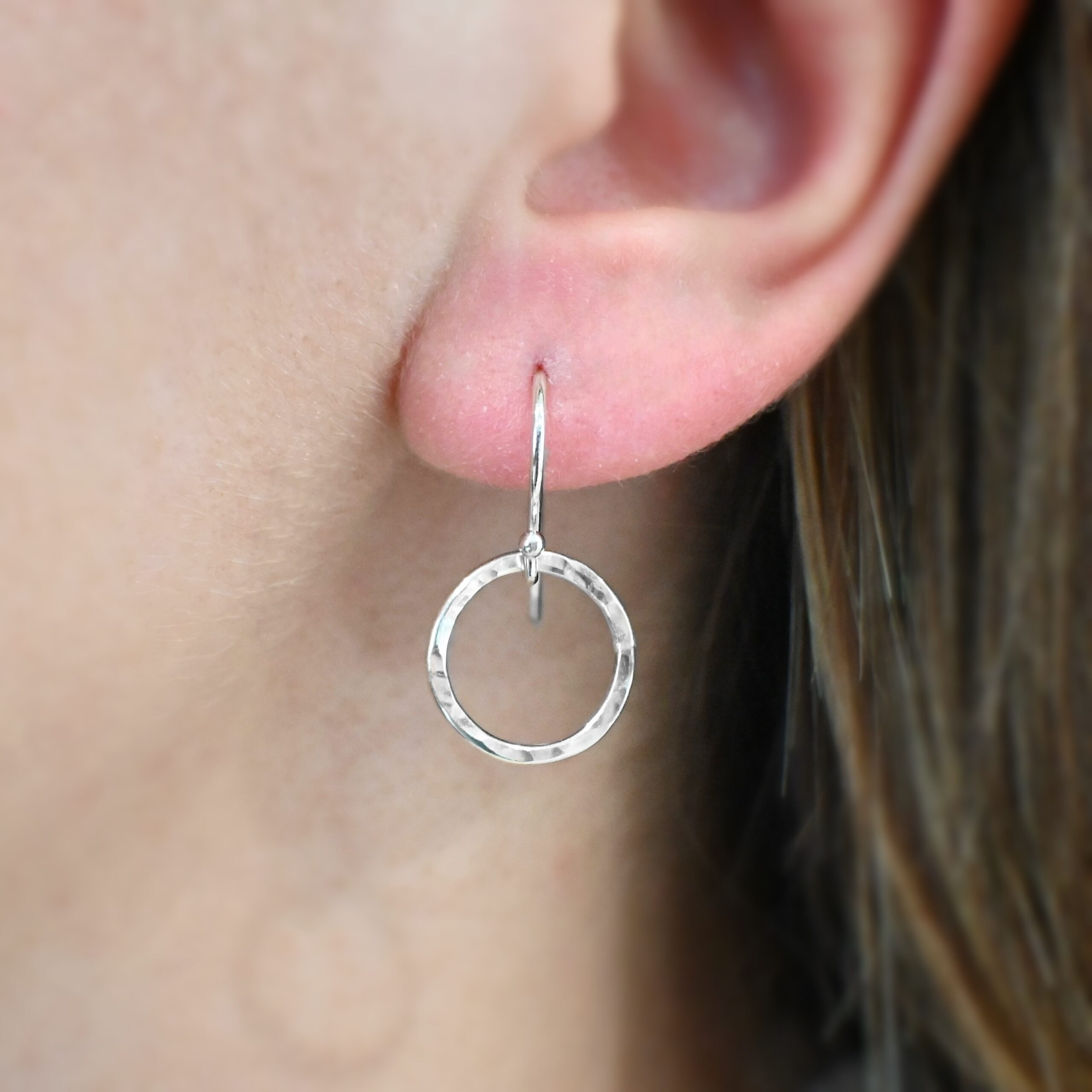 Sterling Silver Fawna Hammered Circle Earrings shiny shown on model