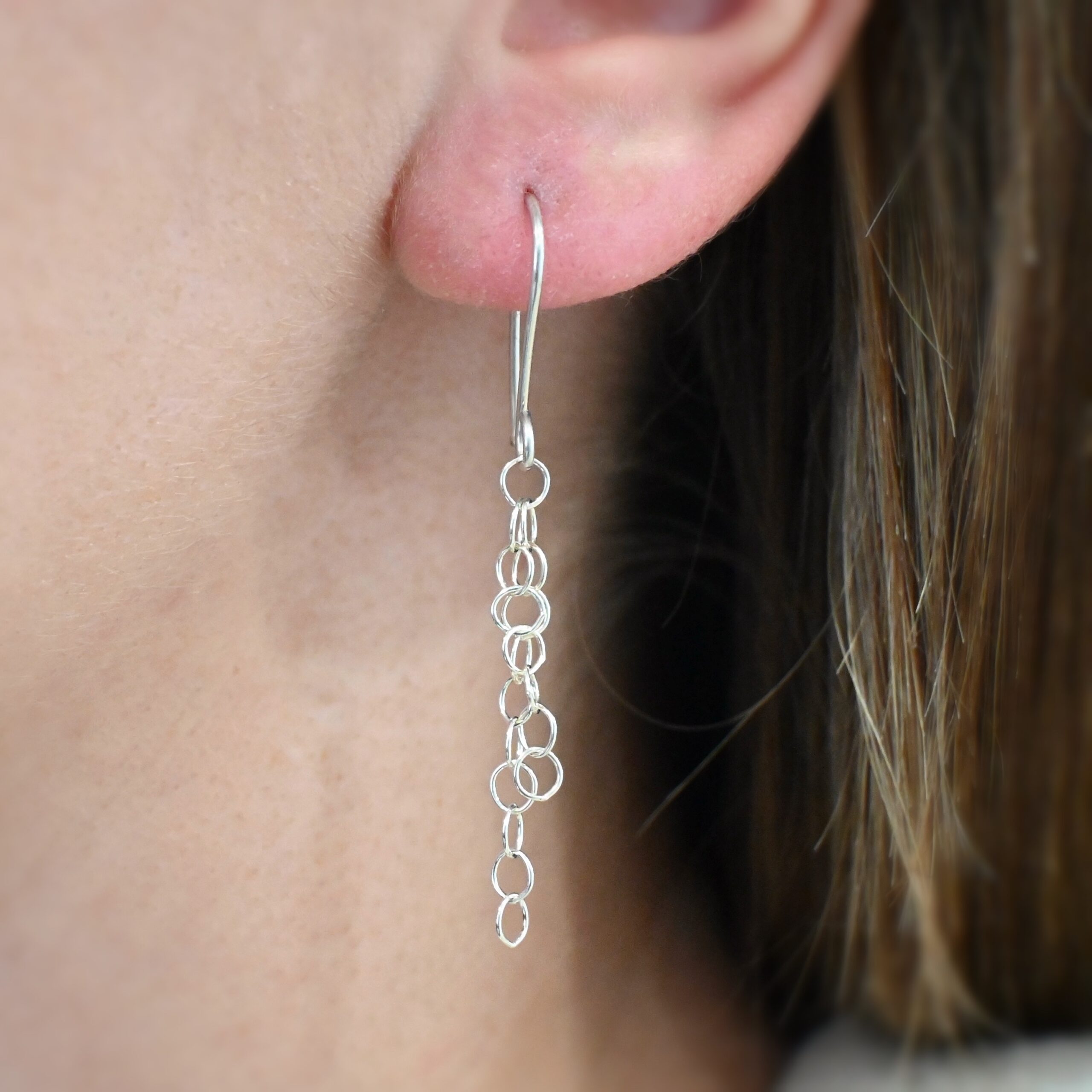 Sterling Silver Florella Hammered Circle Earrings shiny shown on model