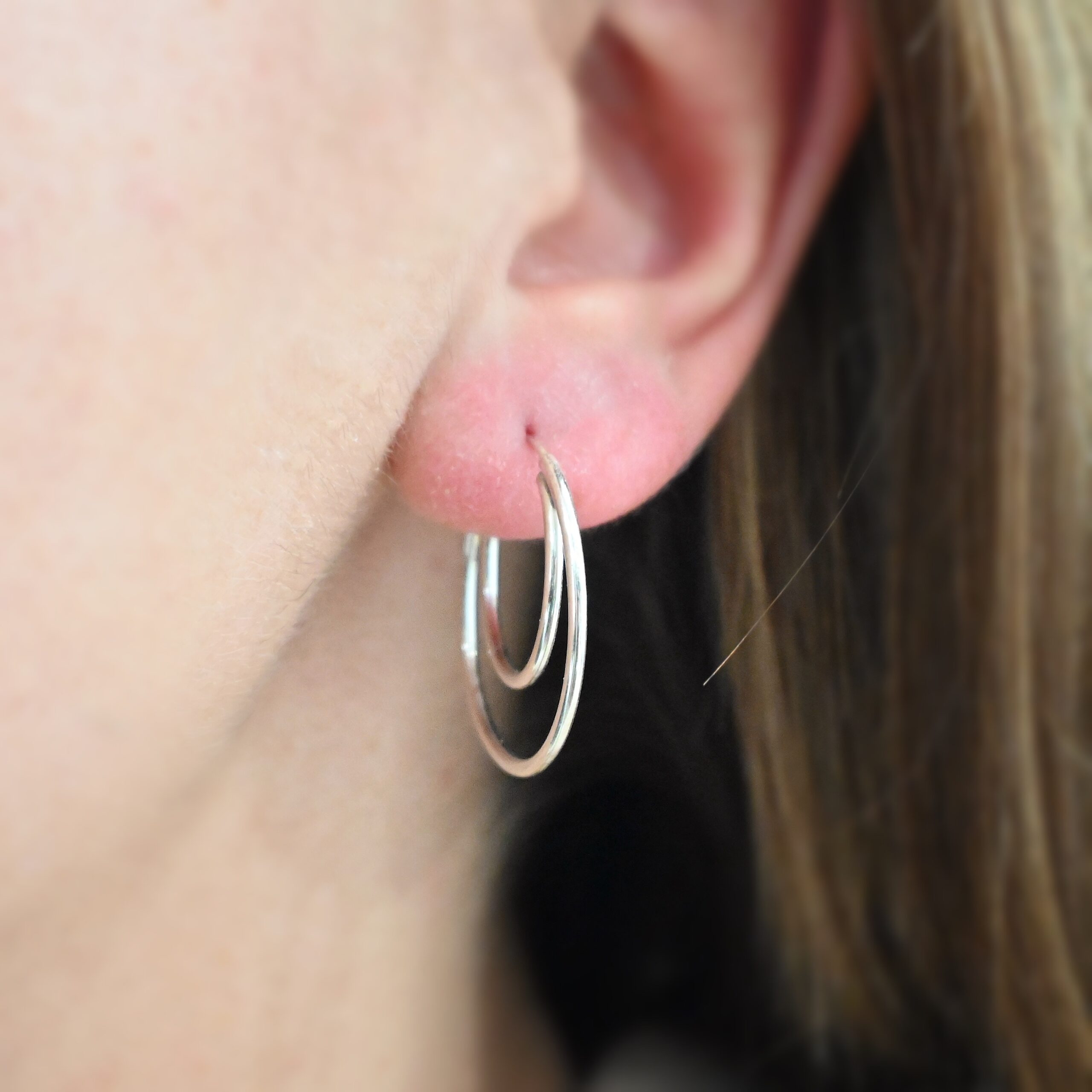 Sterling Silver Fern Double Hoop Earrings 25mm shiny shown on model