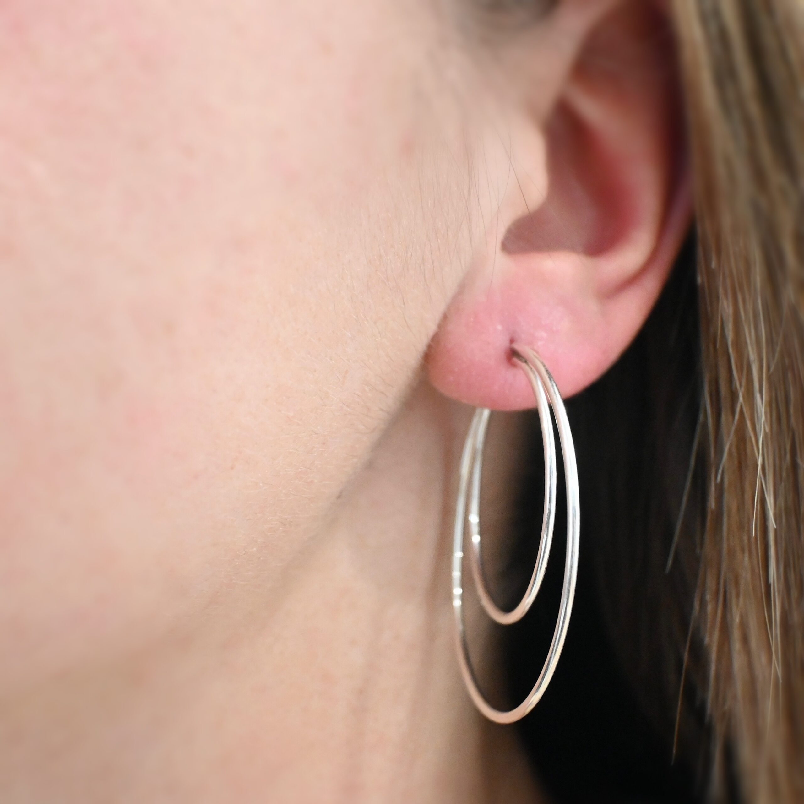 Sterling Silver Fern Double Hoop Earrings 45mm shiny shown on model