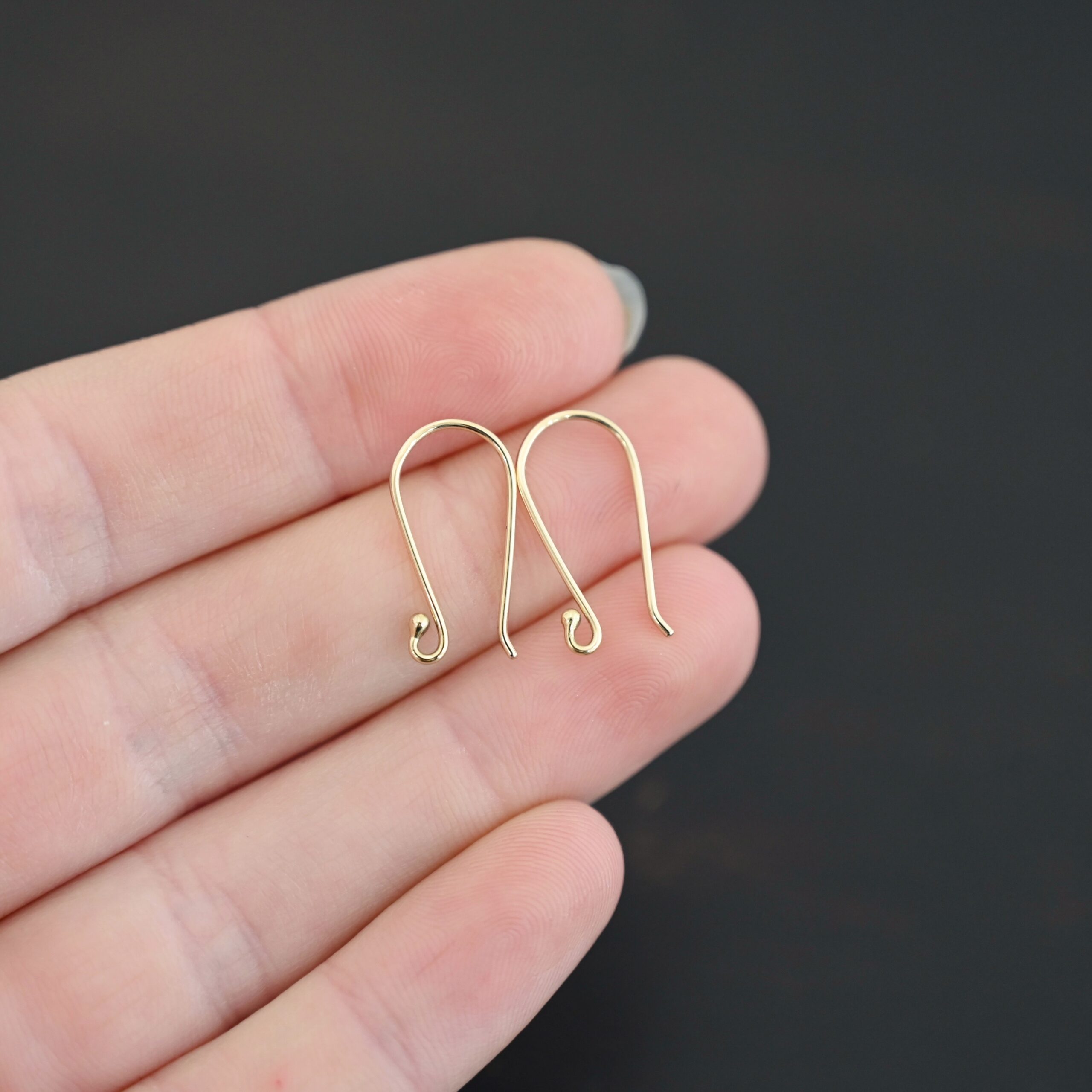 18k gold Whitney Ear Wire shown in hand