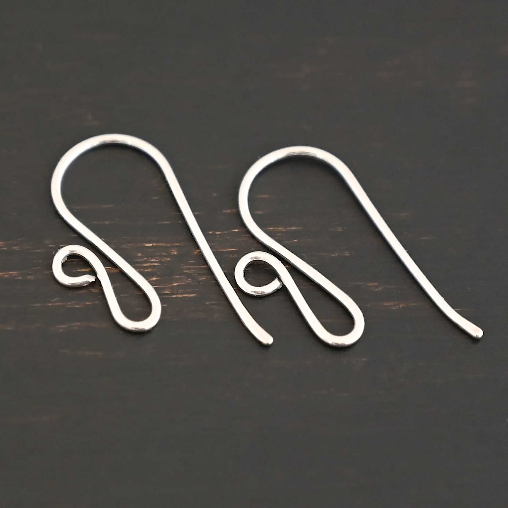 sterling silver Woodlyn Ear Wire - shiny shown on dark background