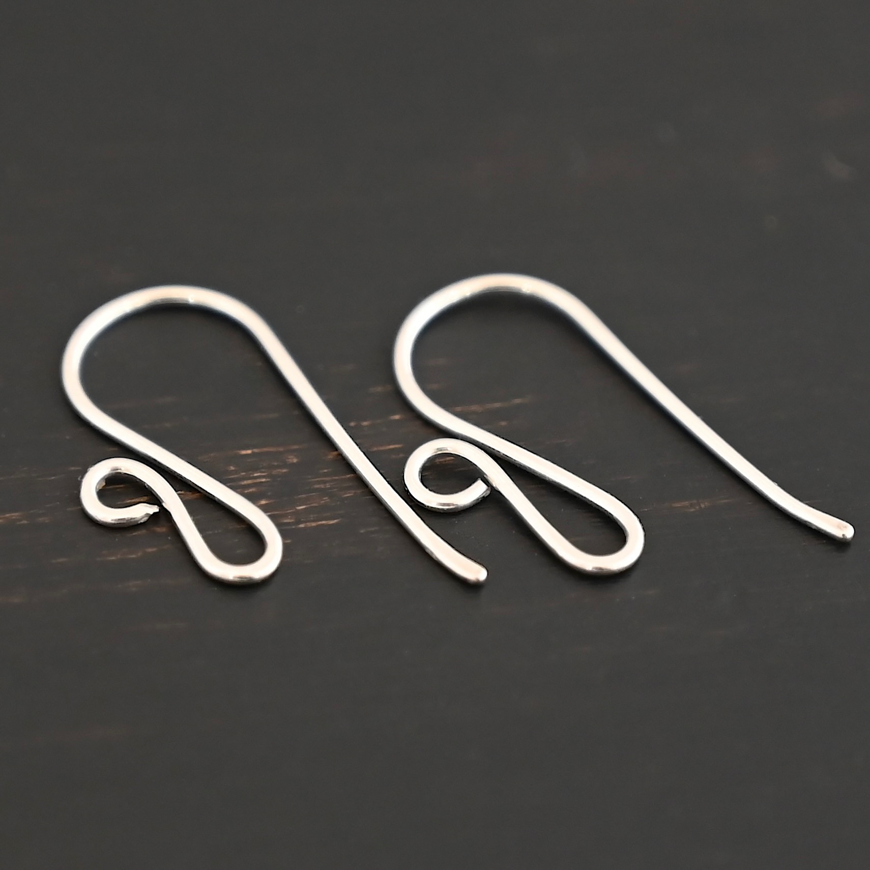 sterling silver Woodlyn Ear Wire - shiny shown on dark background