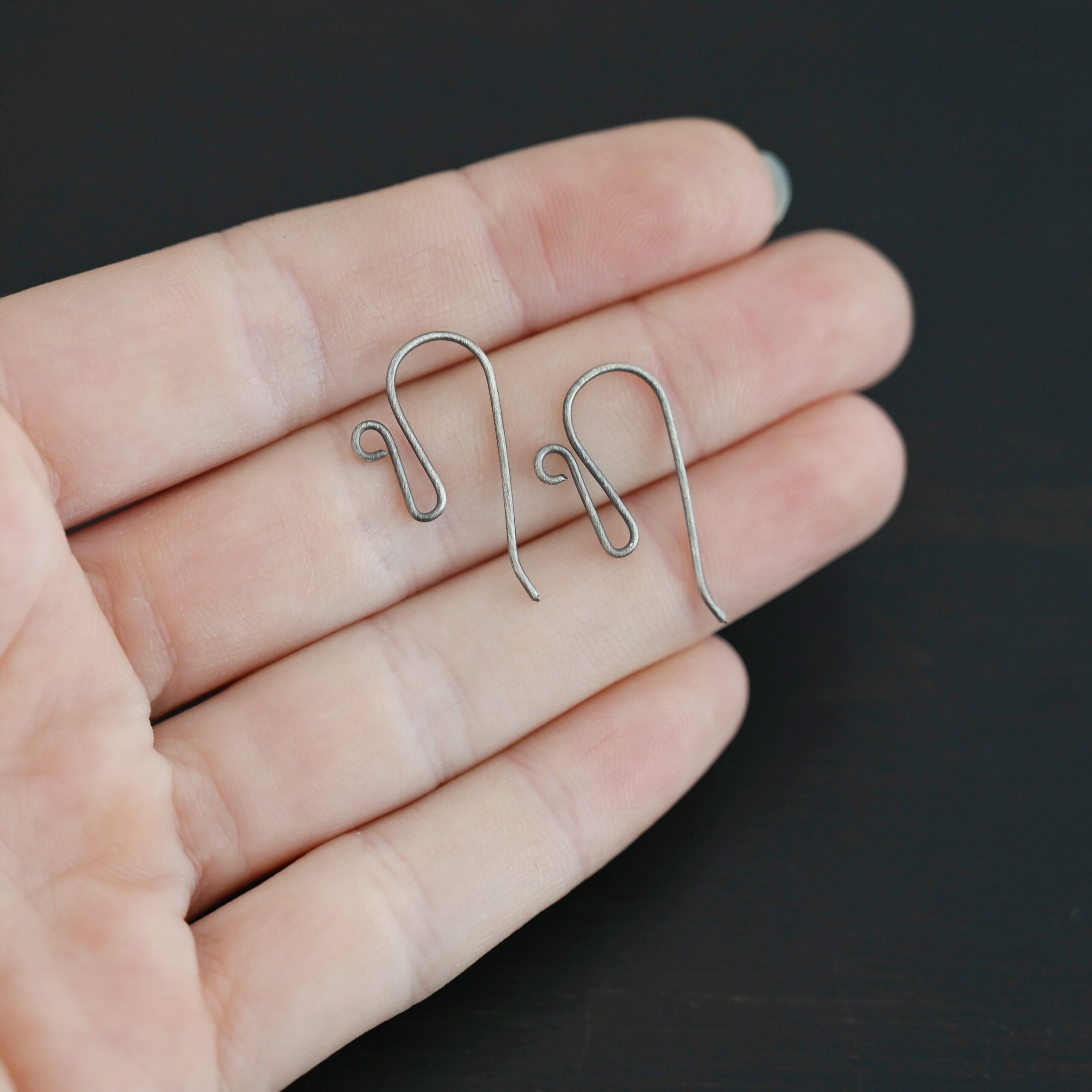 sterling silver Woodlyn Ear Wire - oxidized shown in hand