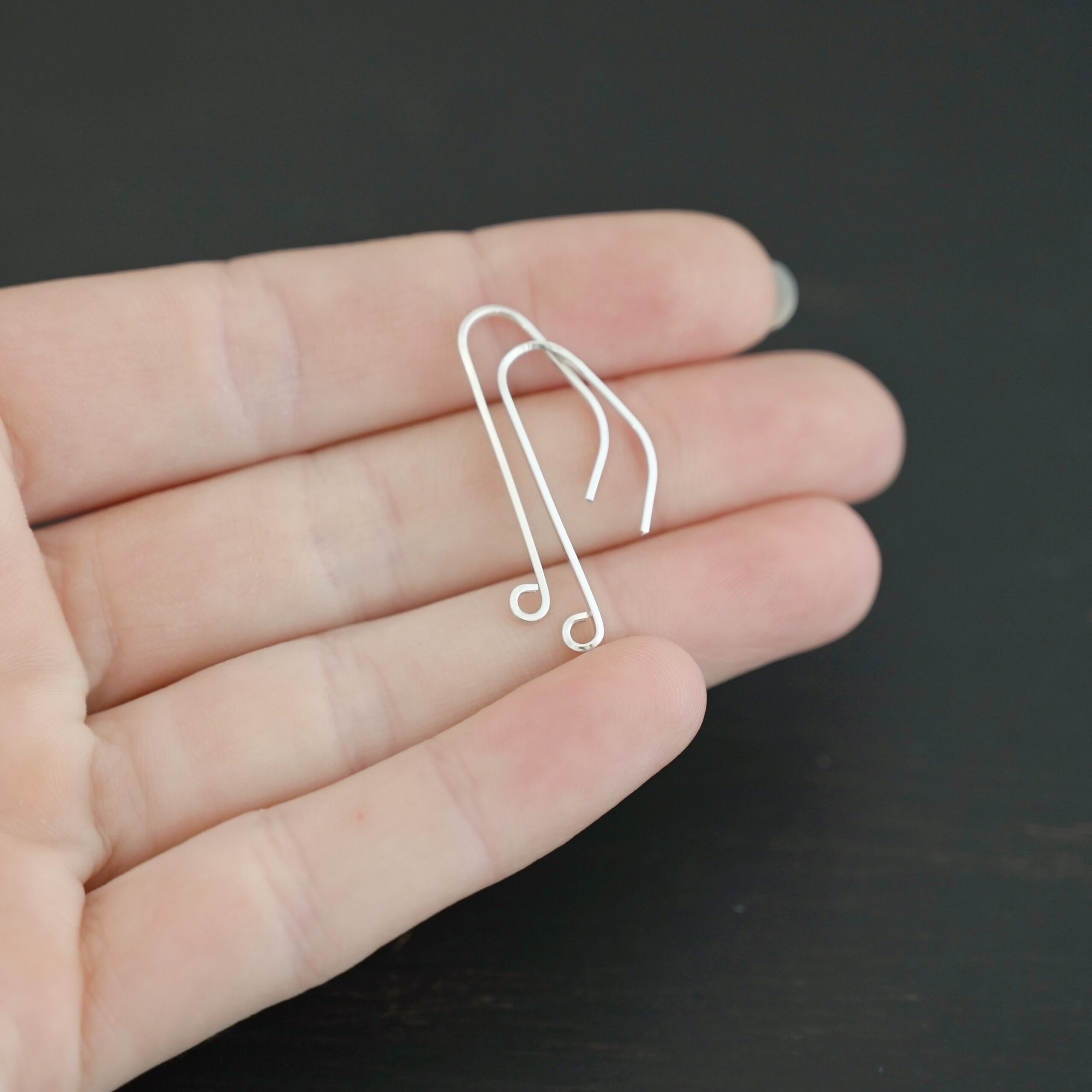 sterling silver Whimsical Ear Wire - shiny 1" shown in hand