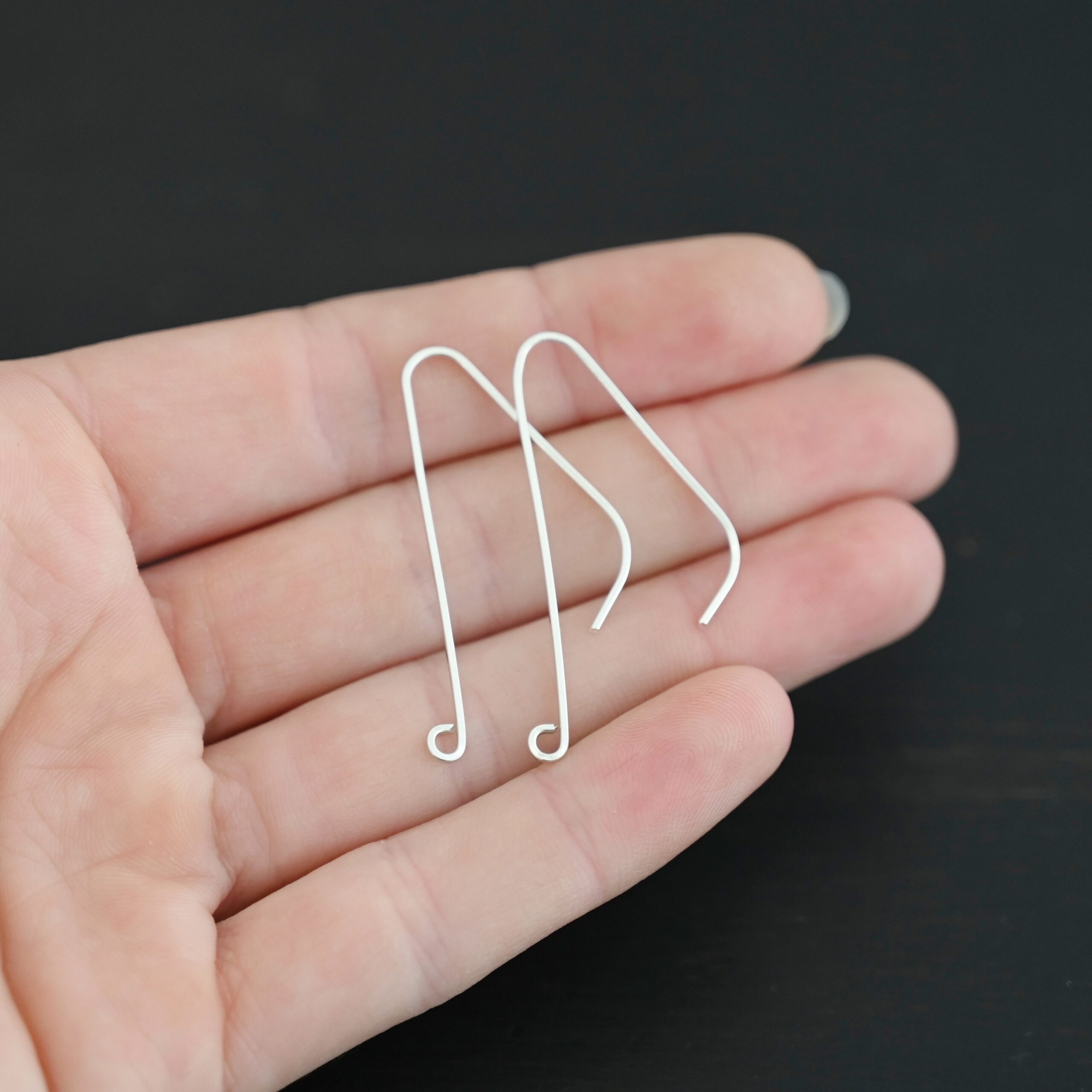 sterling silver Whimsical Ear Wire - shiny 1.5" shown in hand