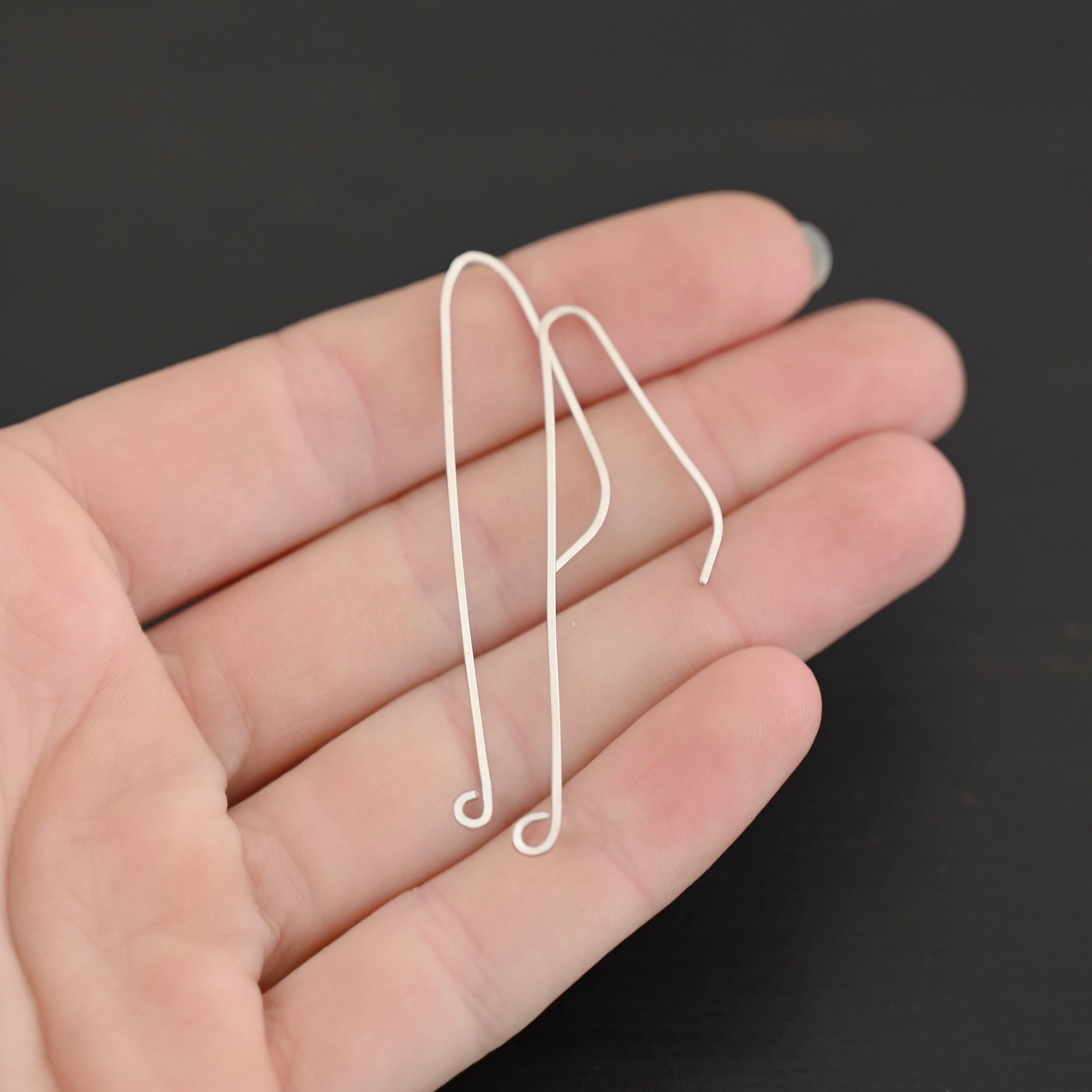 sterling silver Whimsical Ear Wire - shiny 2" shown in hand