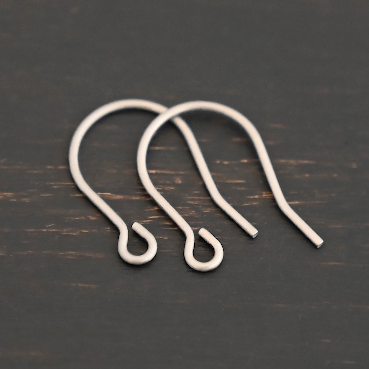 Wednesday Titanium Ear Wire - 16mm Wednesday Titanium Ear Wire - 16mm shown on dark background