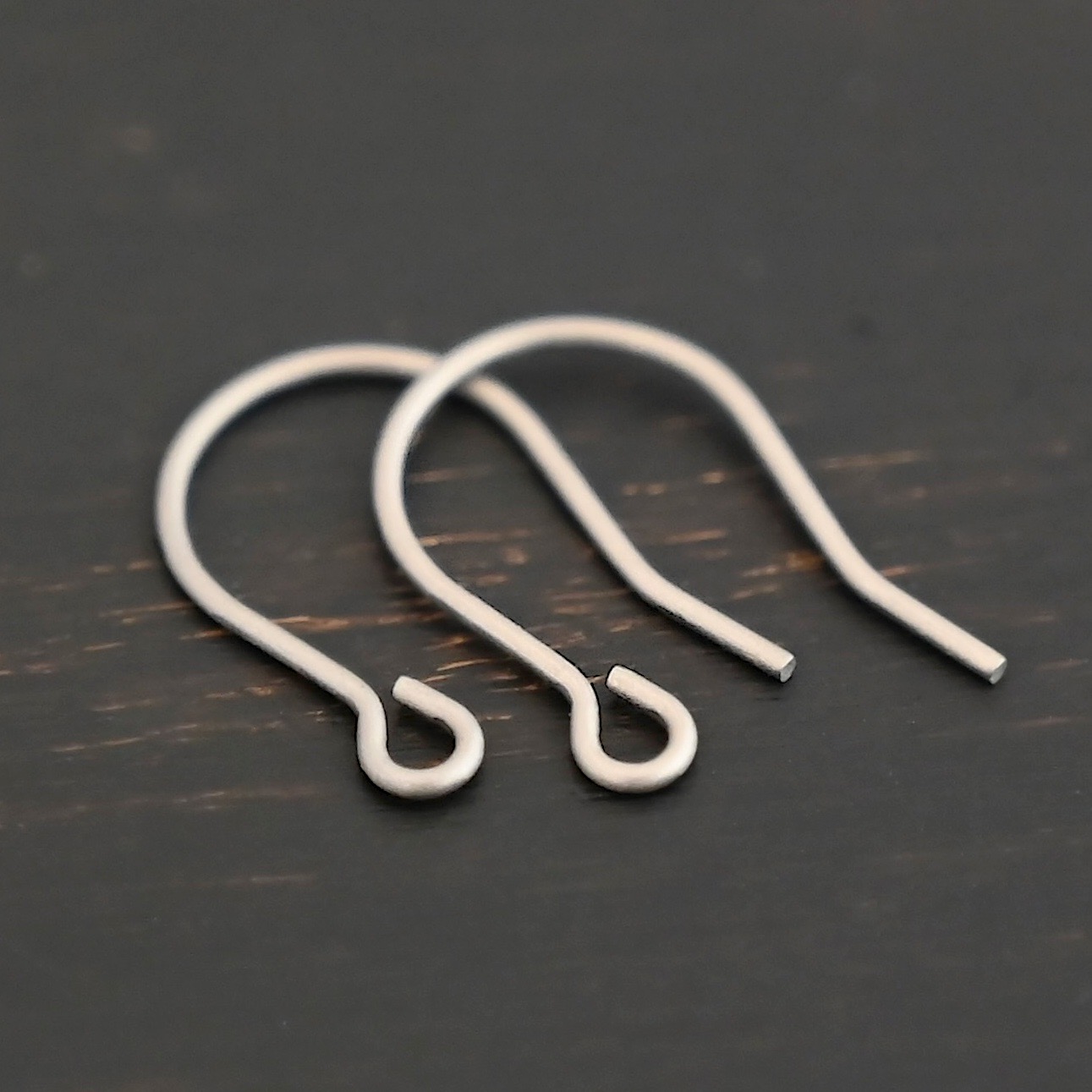 Wednesday Titanium Ear Wire - 16mm Wednesday Titanium Ear Wire - 16mm shown on dark background